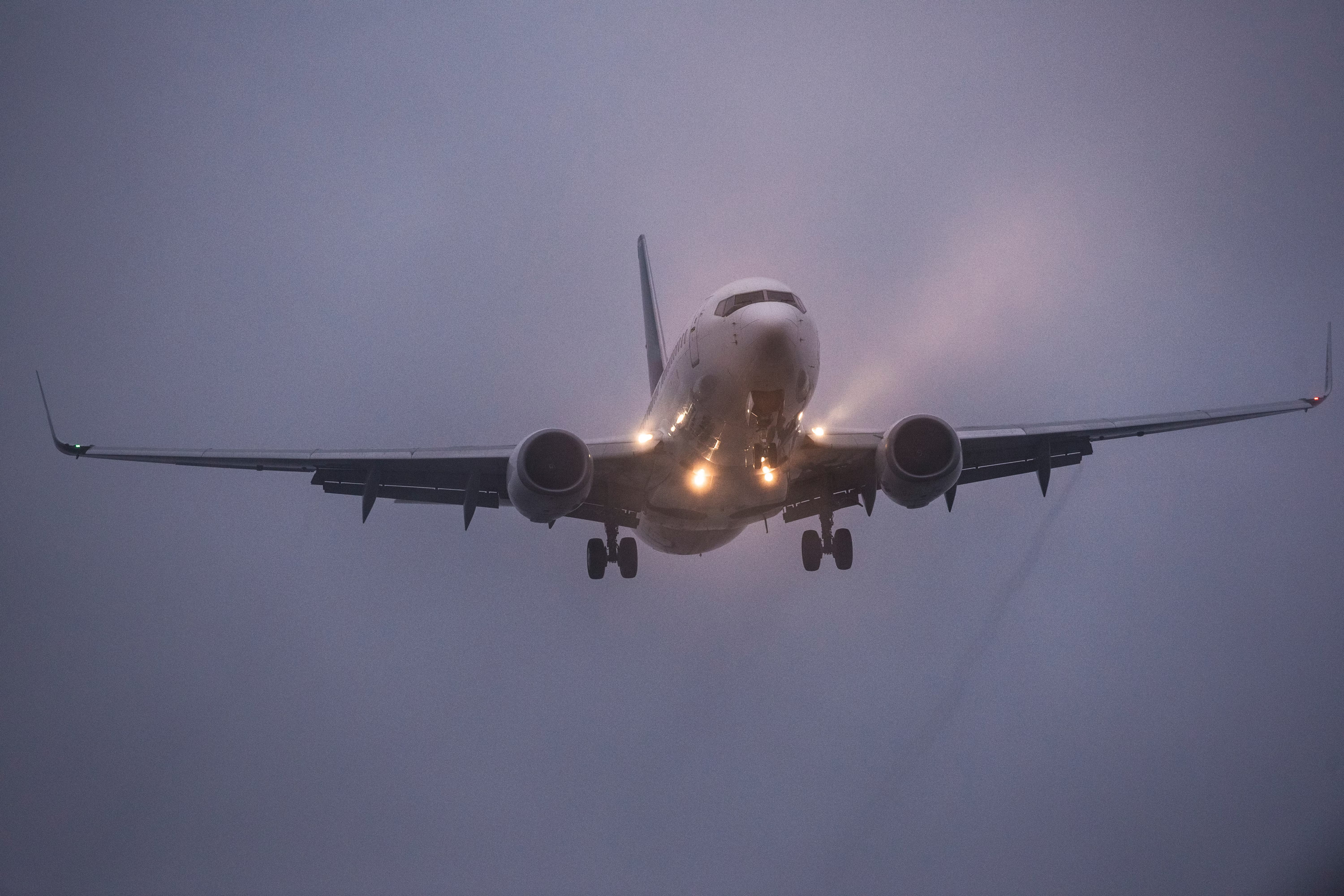 A Boeing 737 landing in foggy conditions.