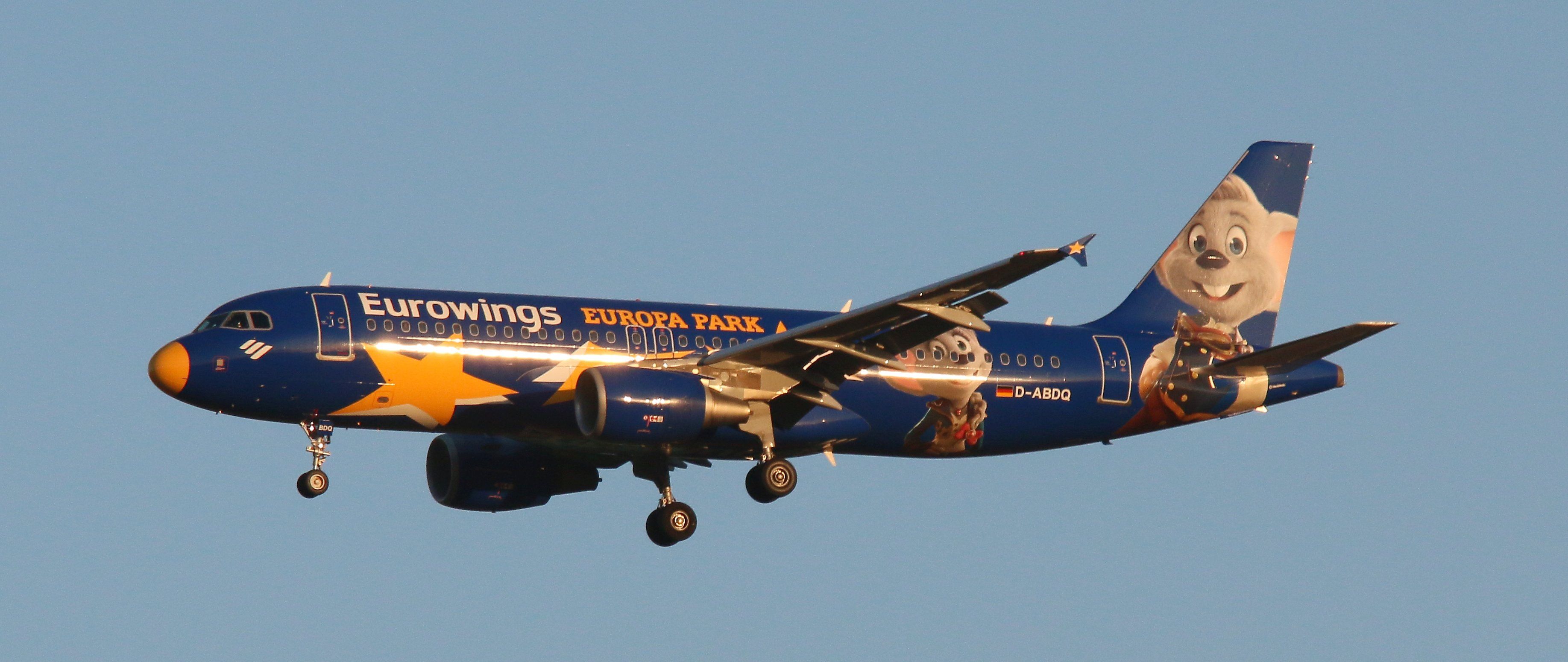 A Eurowings Airbus A320s in Europa Park livery flying in the sky.