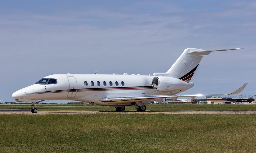 A NetJets Citation Longitude taxiing at an airport.