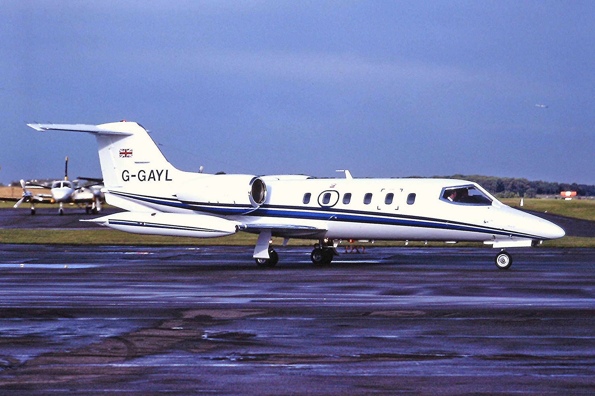 A Learjet 23 taxiing at an airport.