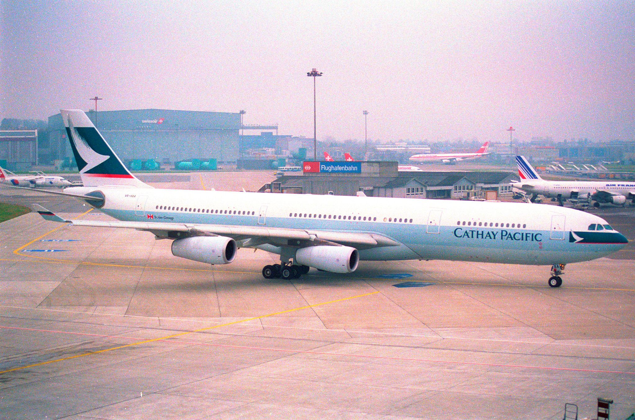 A Cathay Pacific Airbus A340 taxiing to the airport gate.