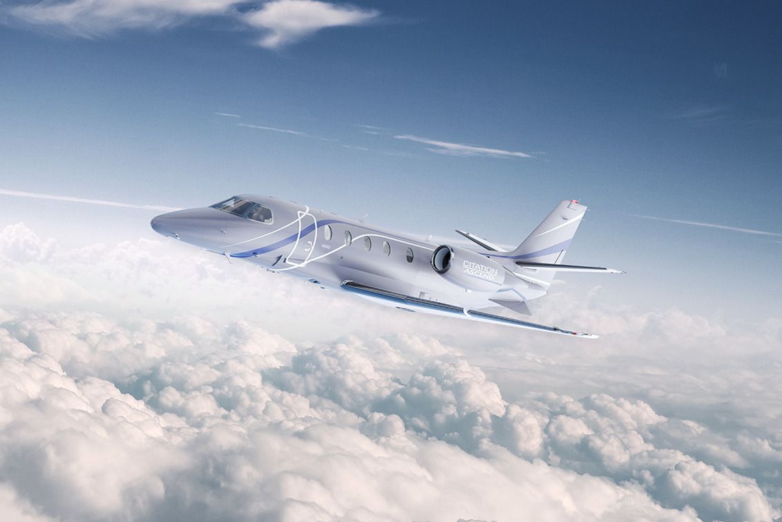 A Cessna Citation Ascend flying above the clouds.