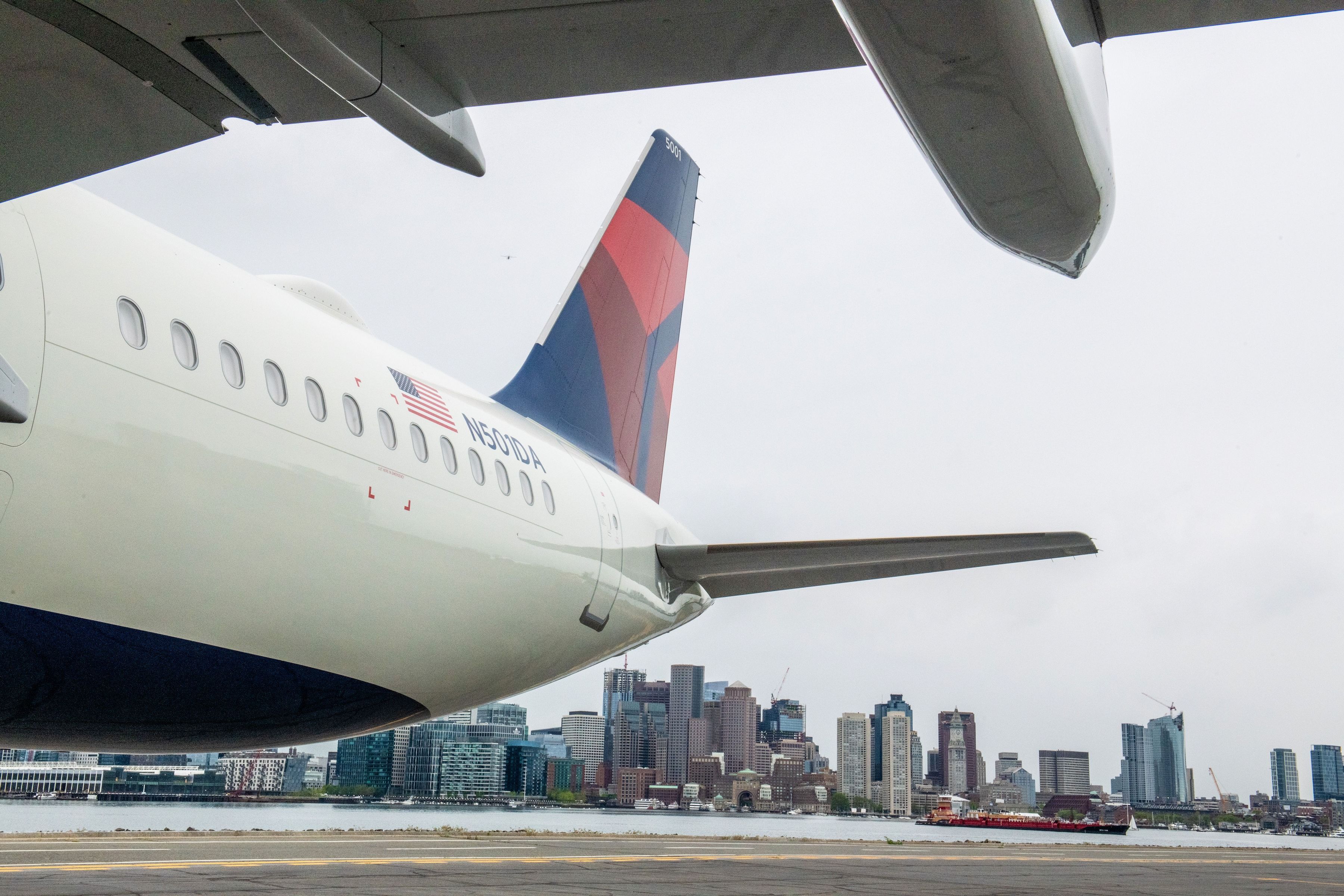 A Delta Air Lines Airbus A321neo with the Boston skyline in the background.