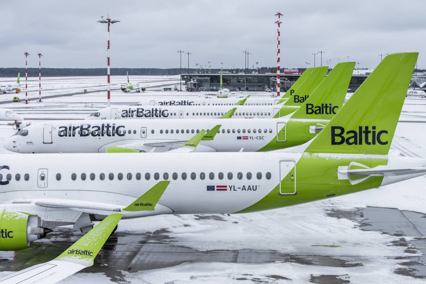 Several airBaltic aircraft parked side by side.