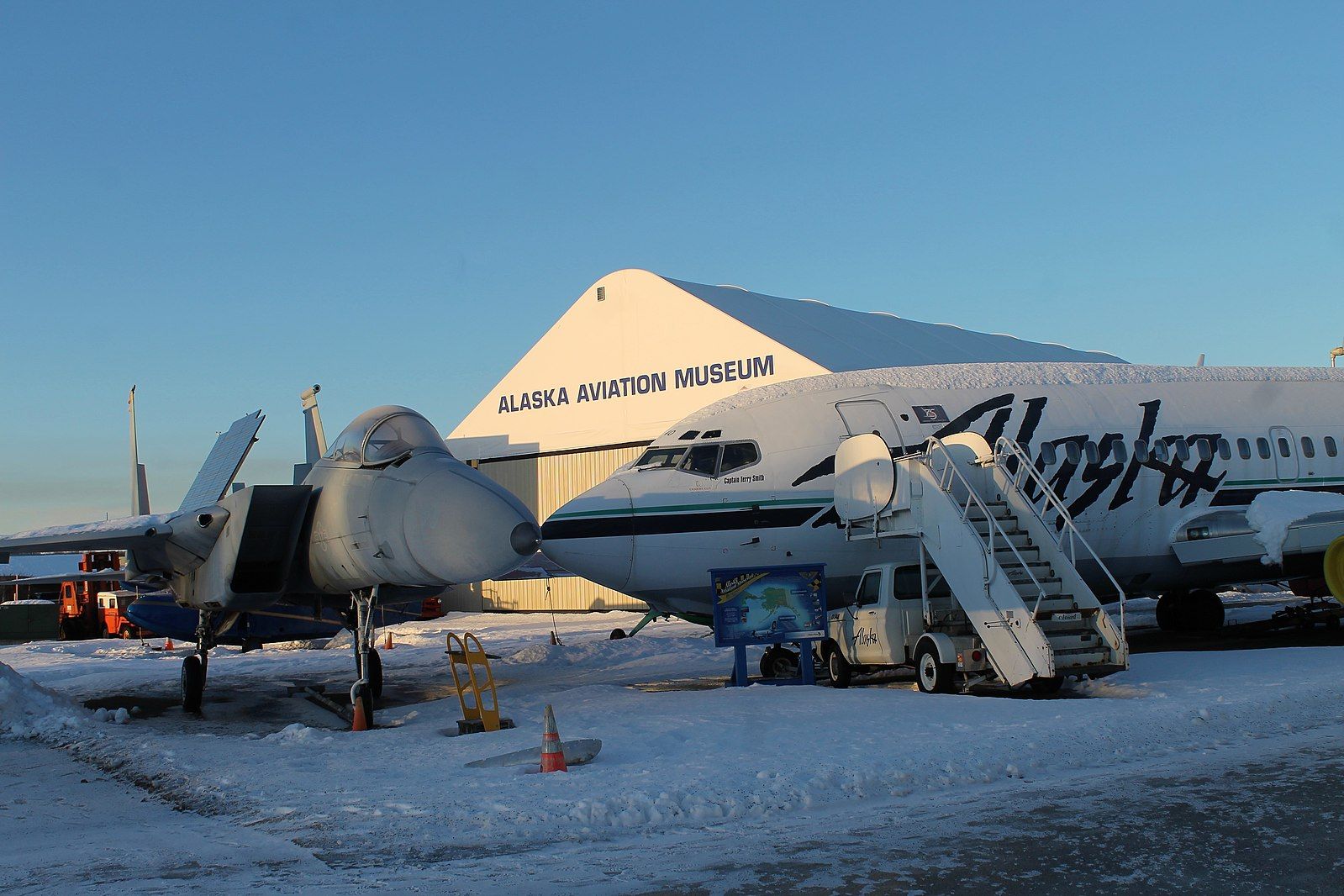 Two aircraft at the Alaska Aviation Museum during winter.