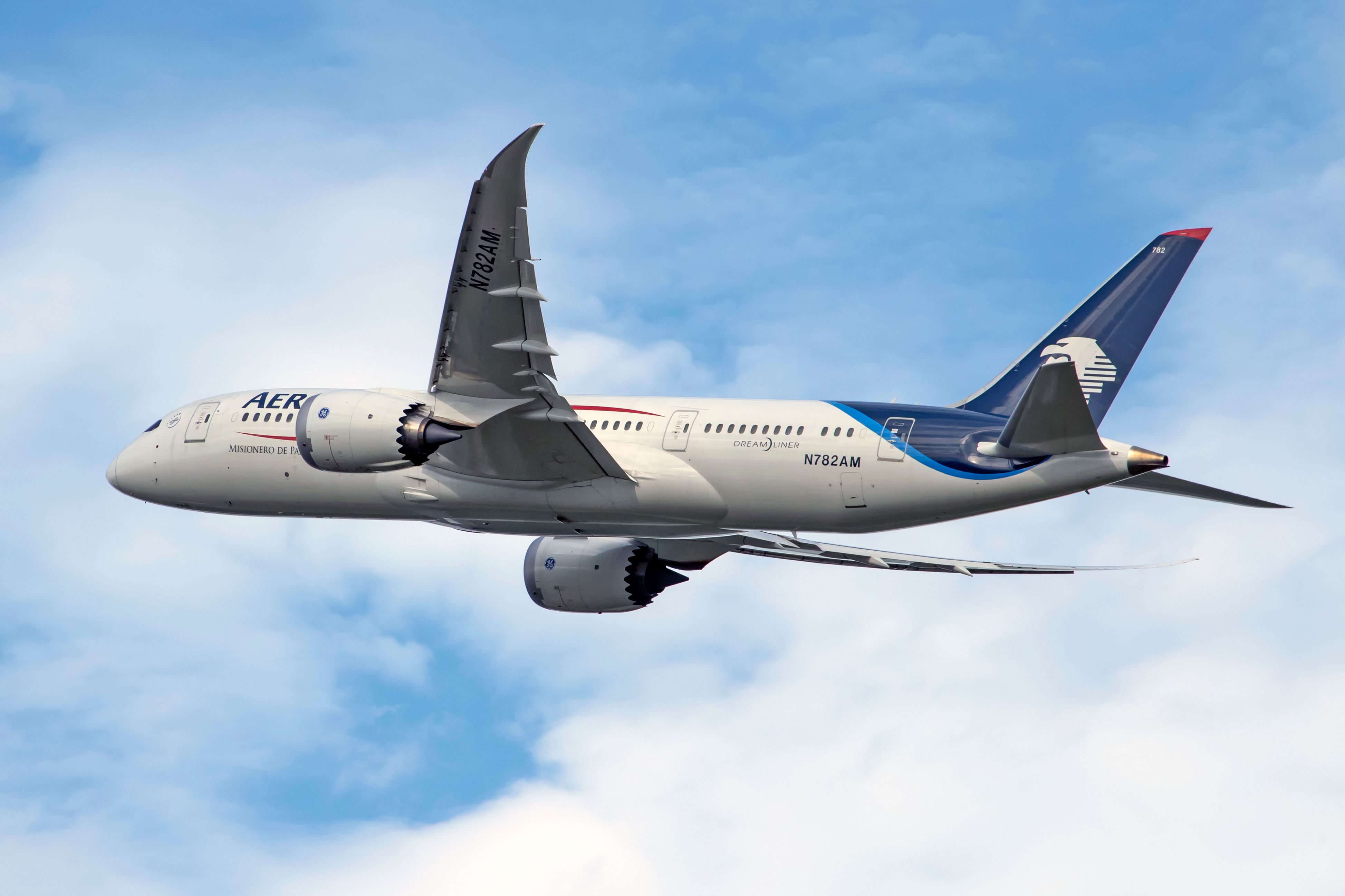 An Aeromexico 787-8 Dreamliner flying in the sky.
