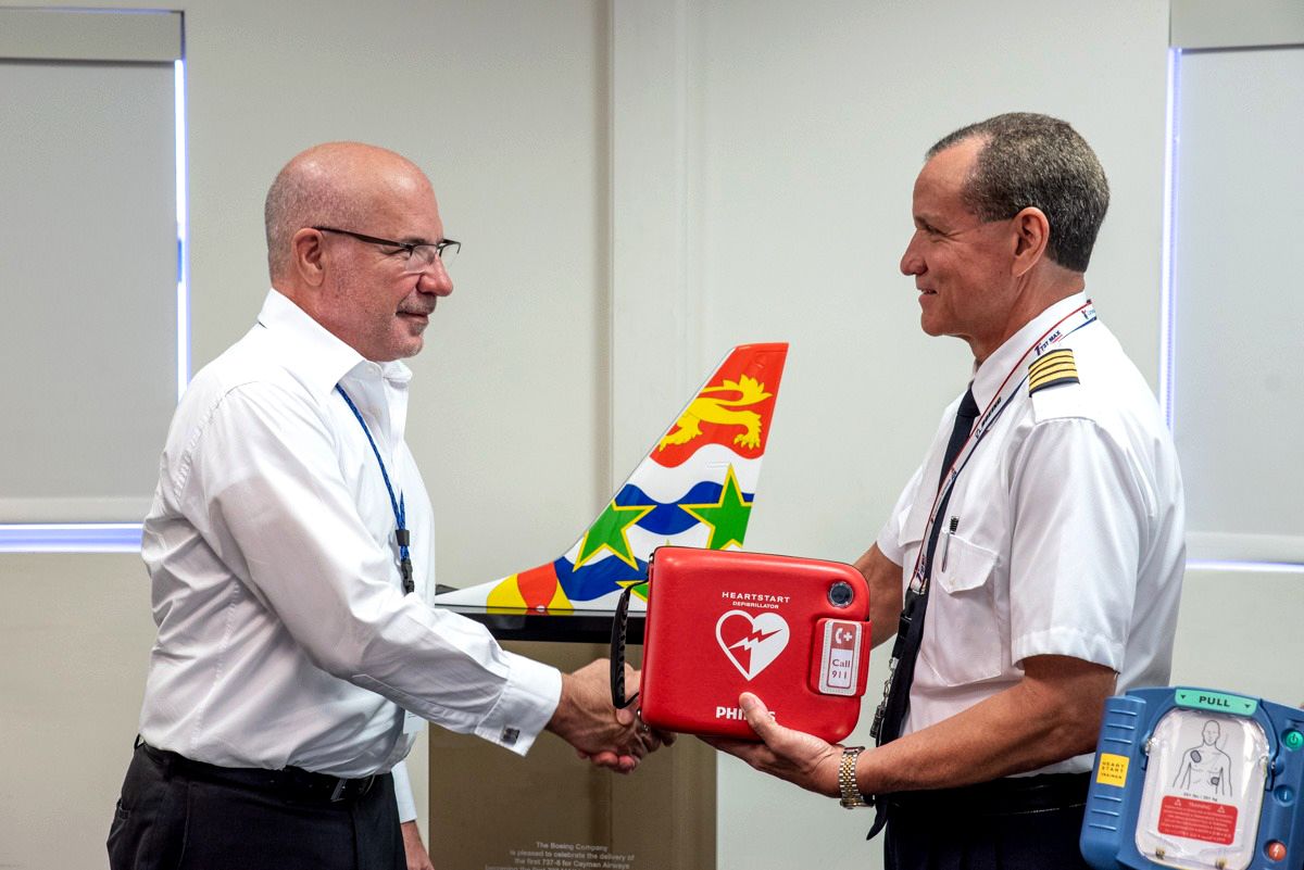 An aircraft captain holding an AED.