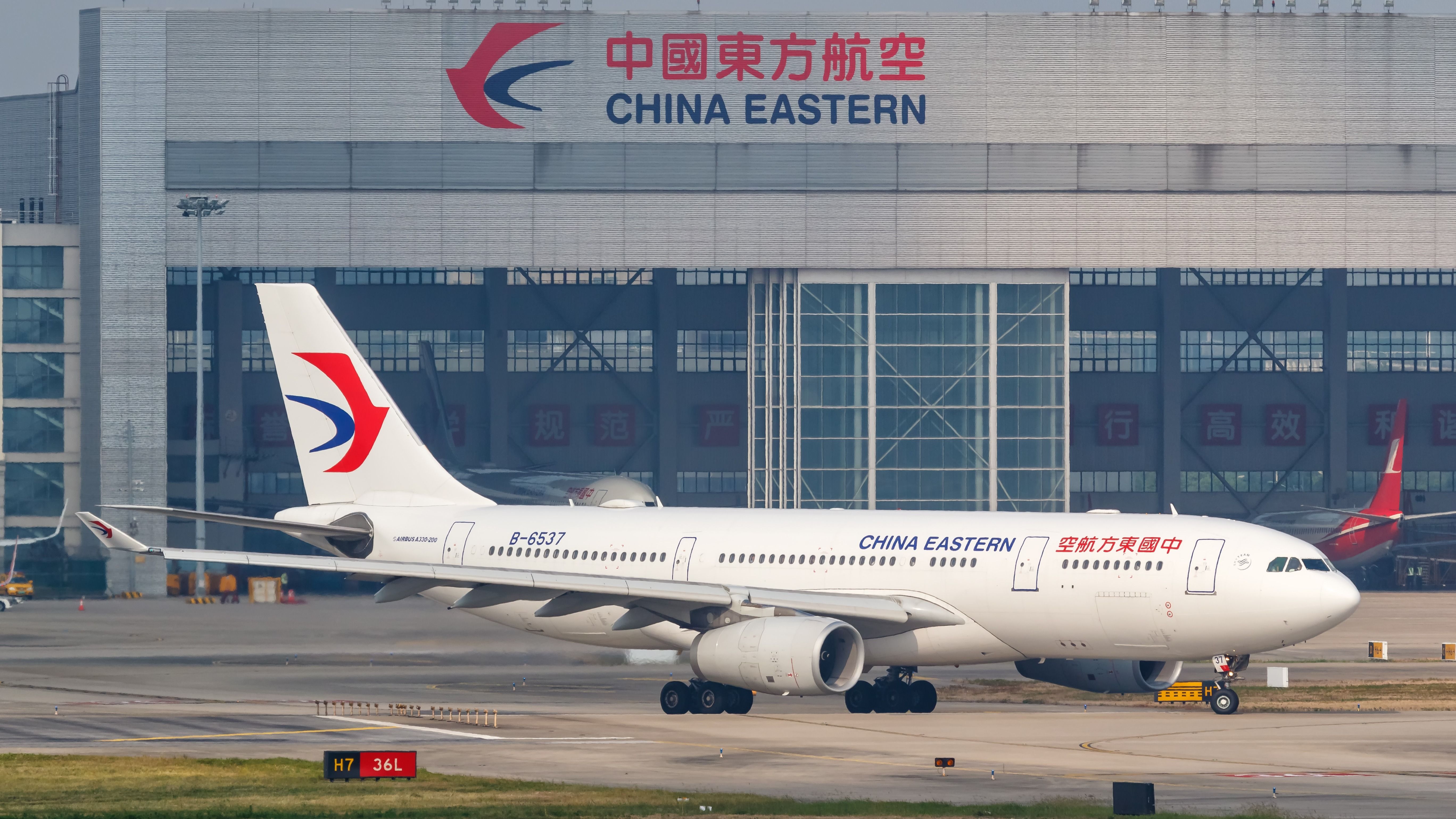 A China Eastern Airlines Airbus A330-200 on an airport apron.