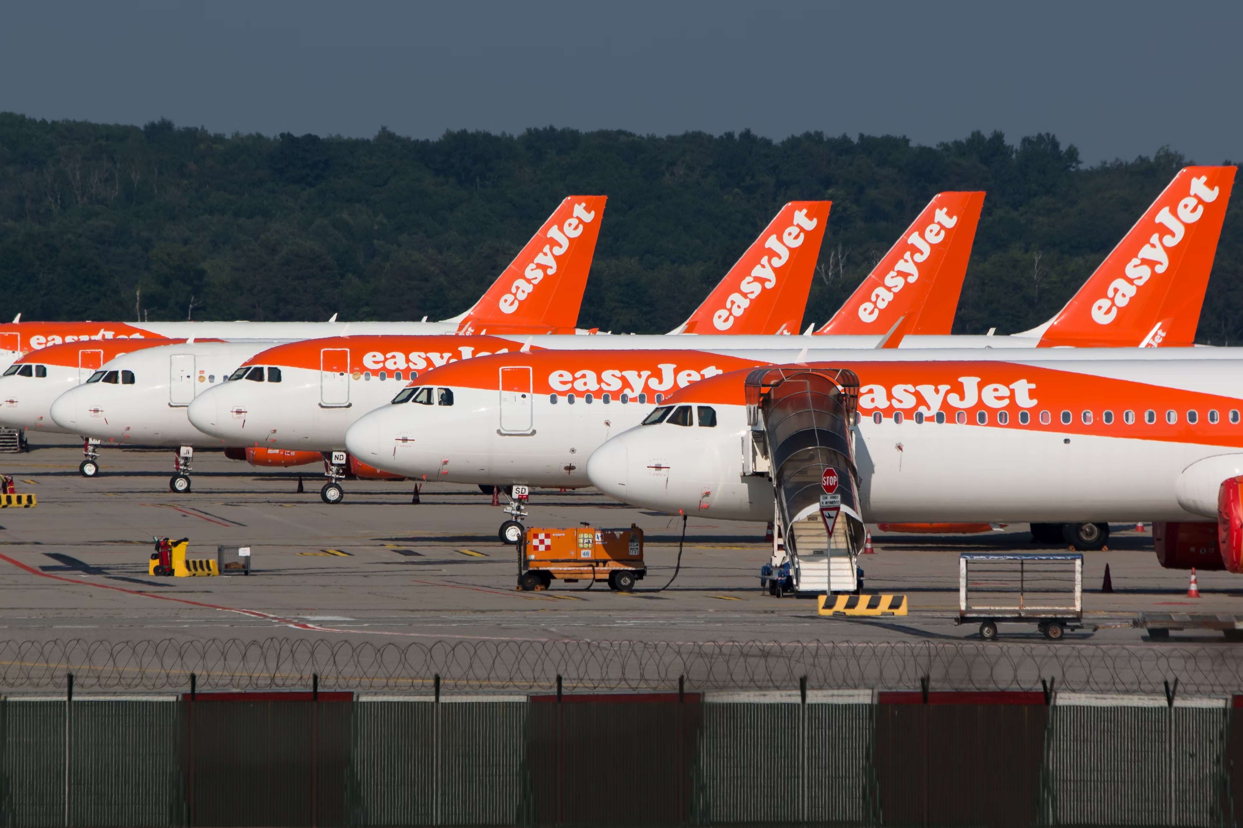 Several easyJet aircraft lined up on the apron.