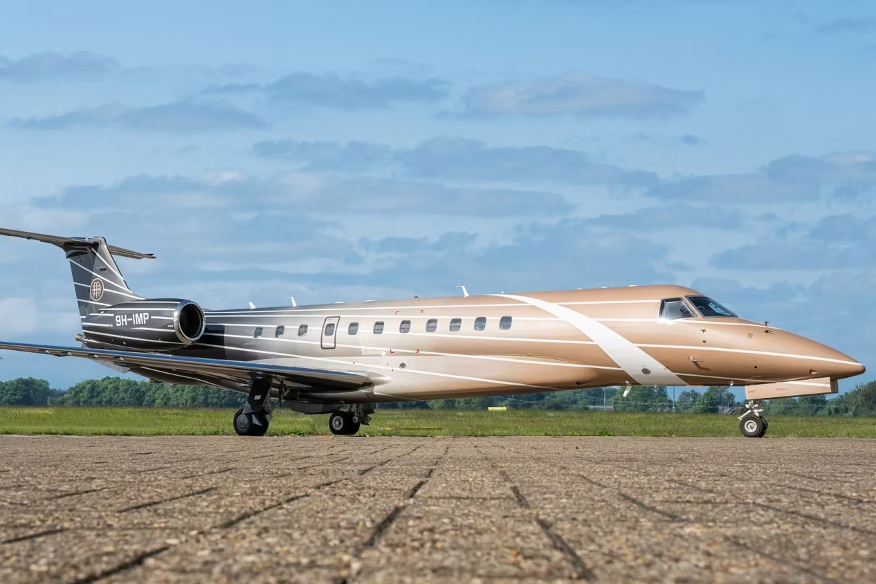 An Aerocare Refurbished Embraer Legacy 600 Private Aircraft Parked At An Airport.