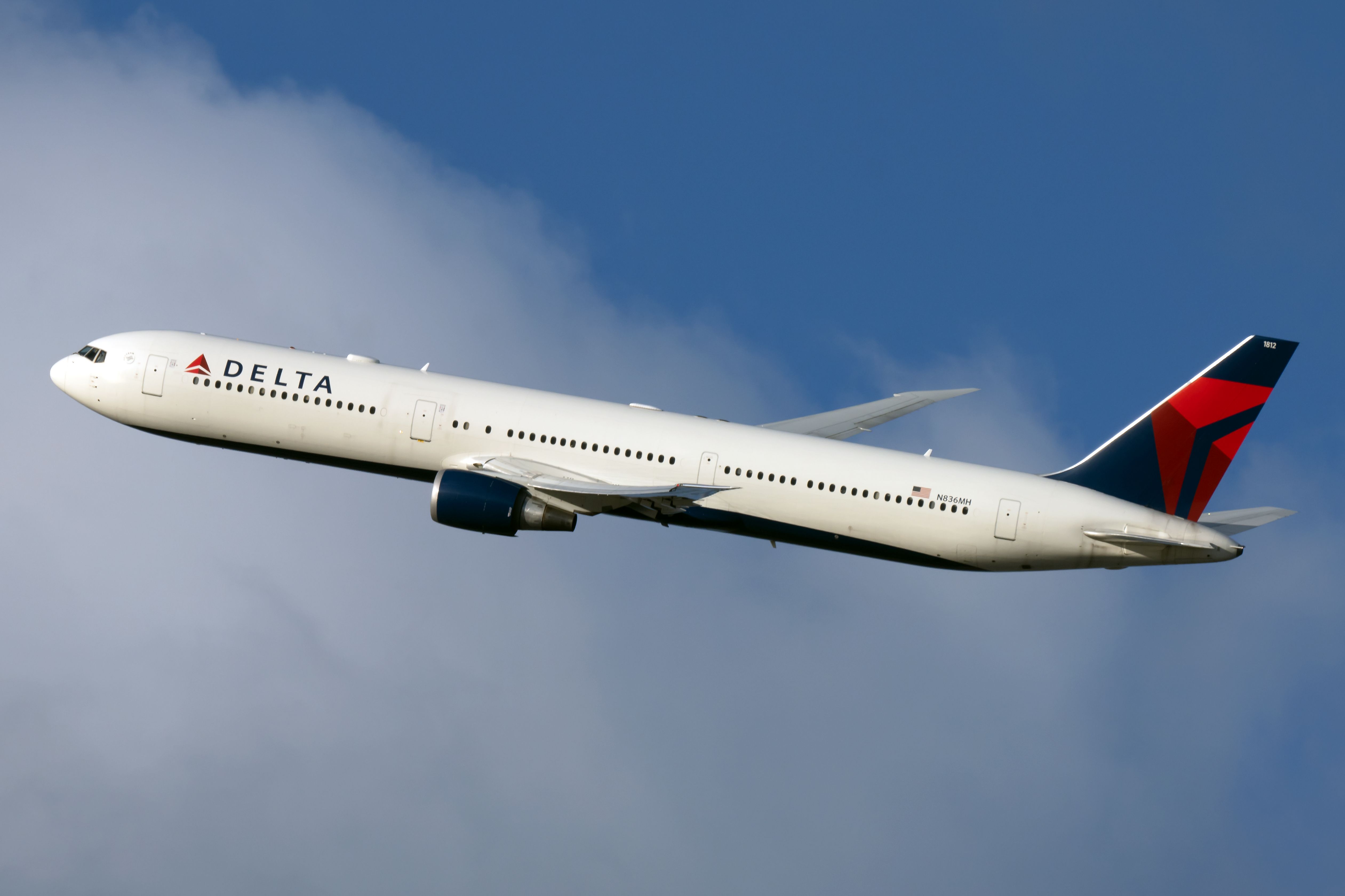 A Delta Air Lines Boeing 767 flying in the sky.