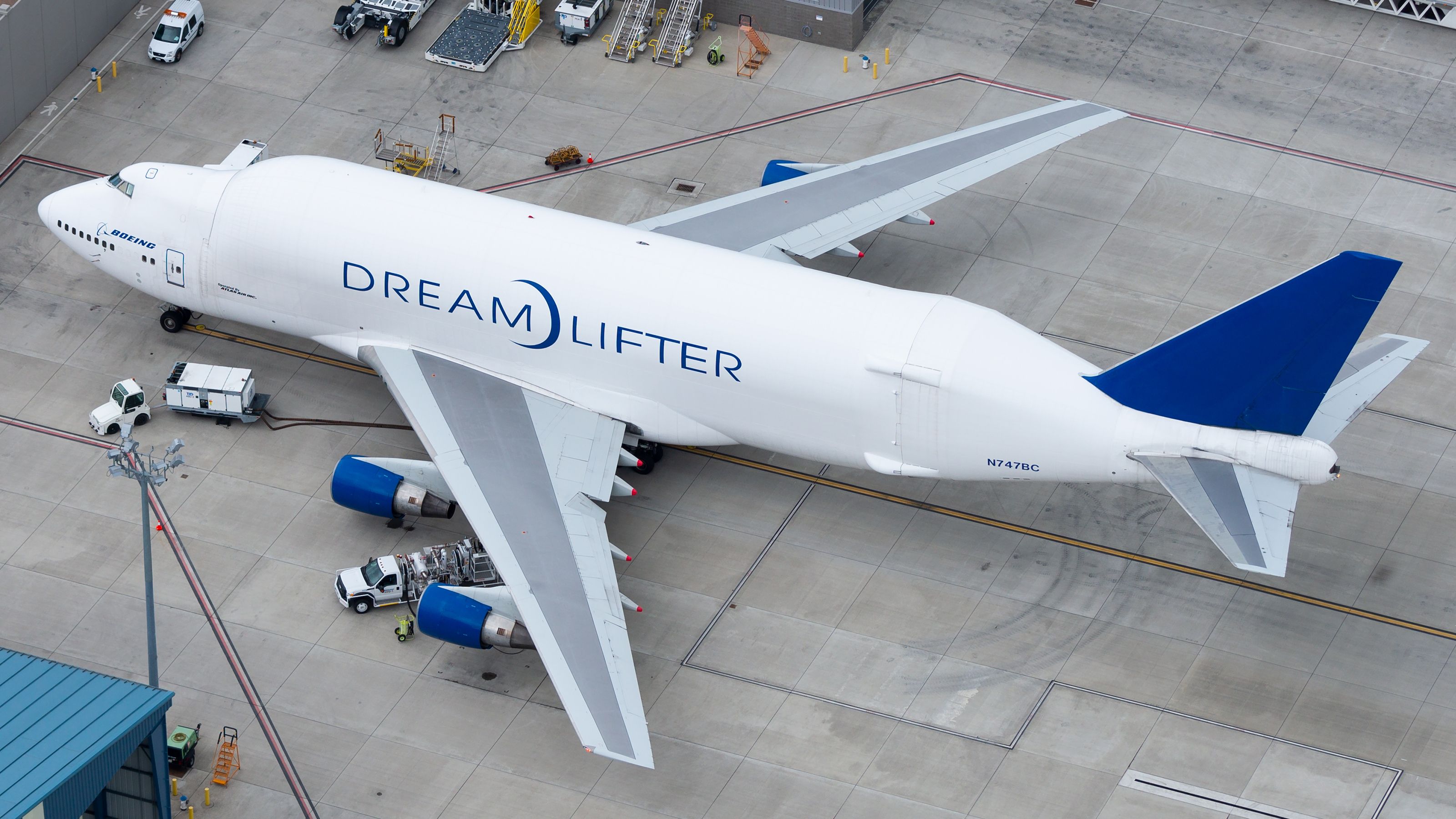 A Boeing Dreamlifter parked at an airport.