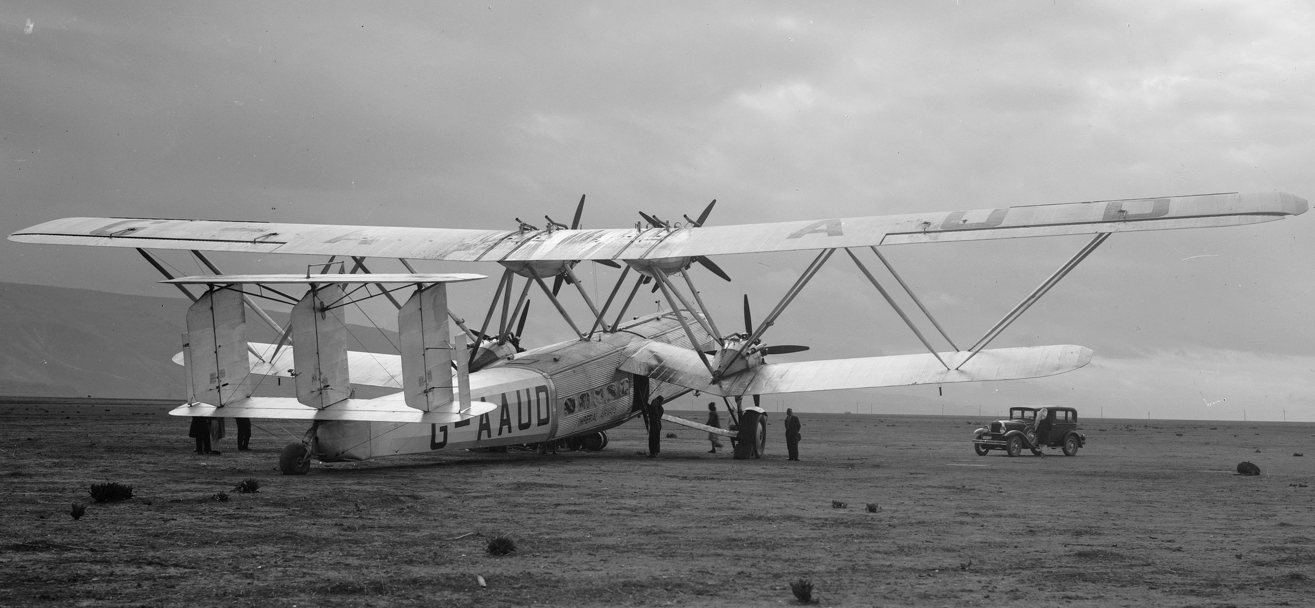 A Handley Page H.P.42 Hanno of the Imperial Airways parked on a field.