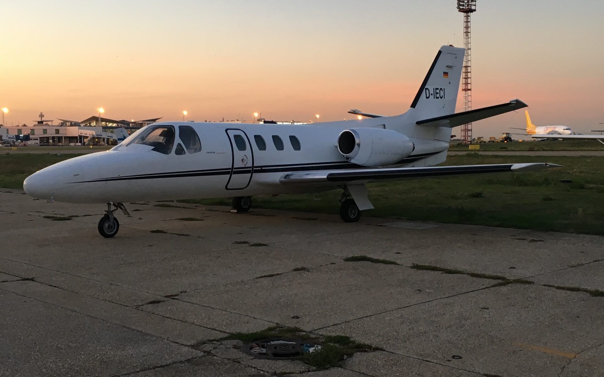 A Cessna Citation 500 parked at an airport.