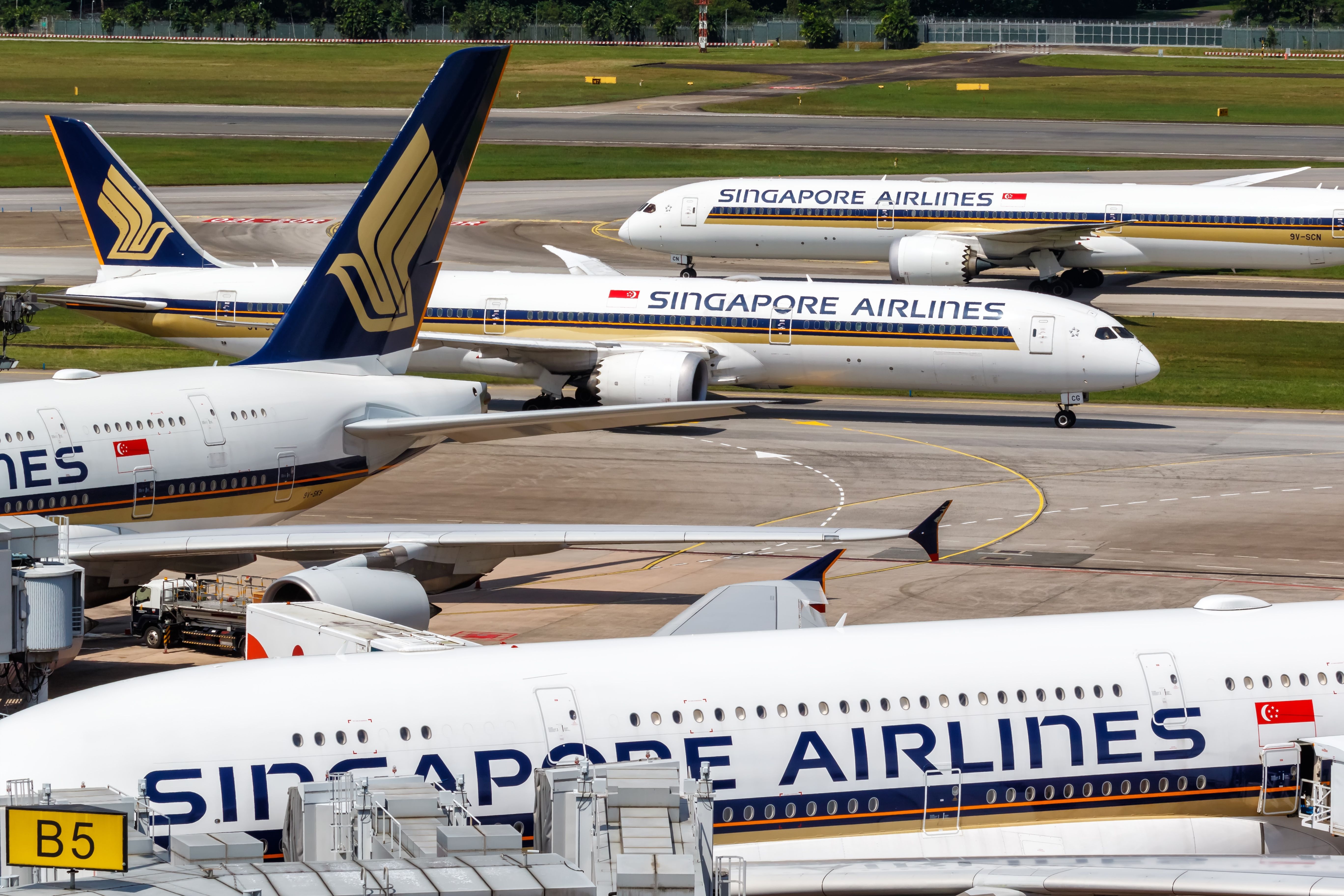 Several Singapore Airlines aircraft parked at Changi Airport.