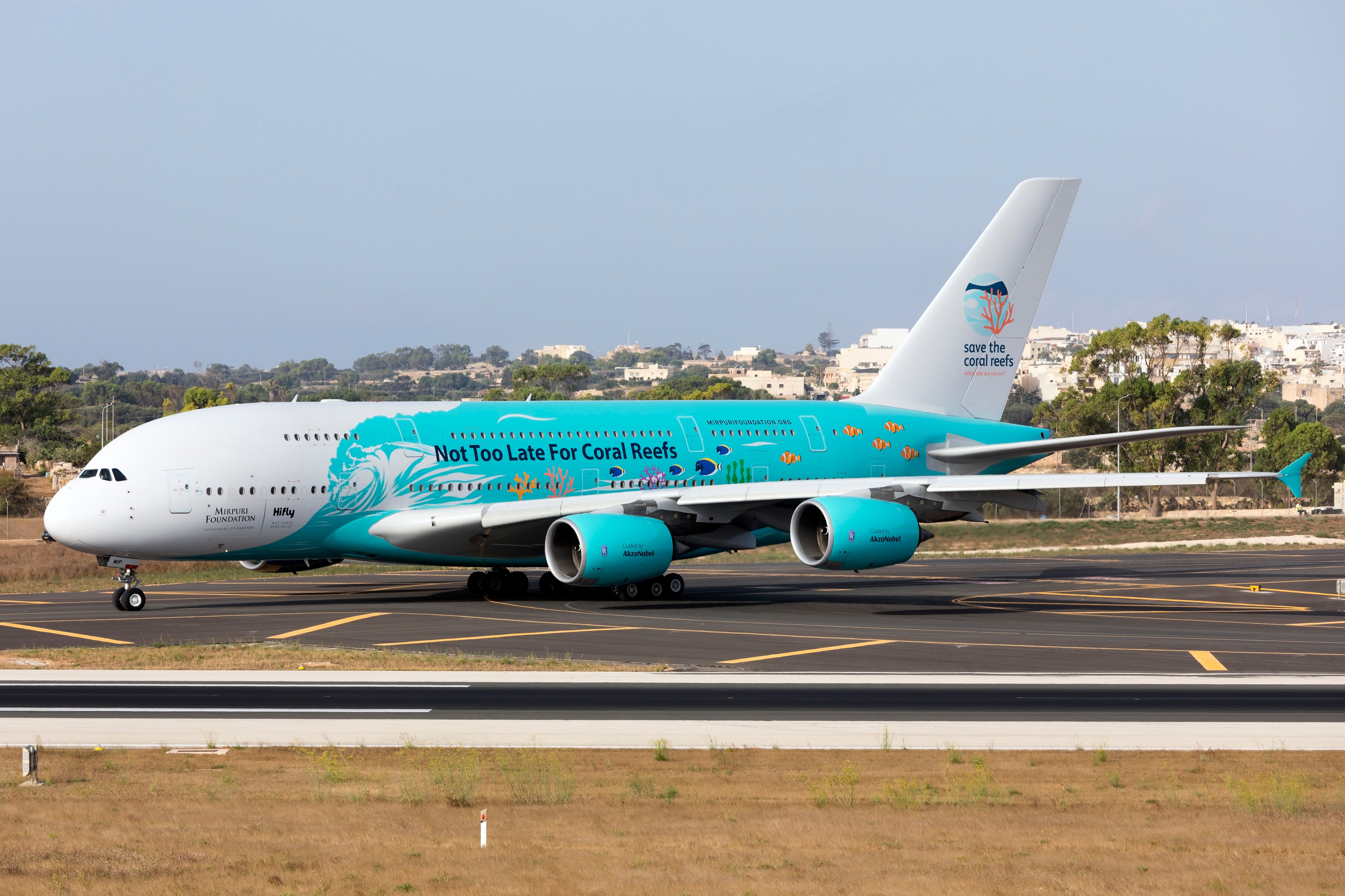 A Hi Fly Malta Airbus A380-841 in a `Save the Coral Reefs` livery taxiing at an airport.
