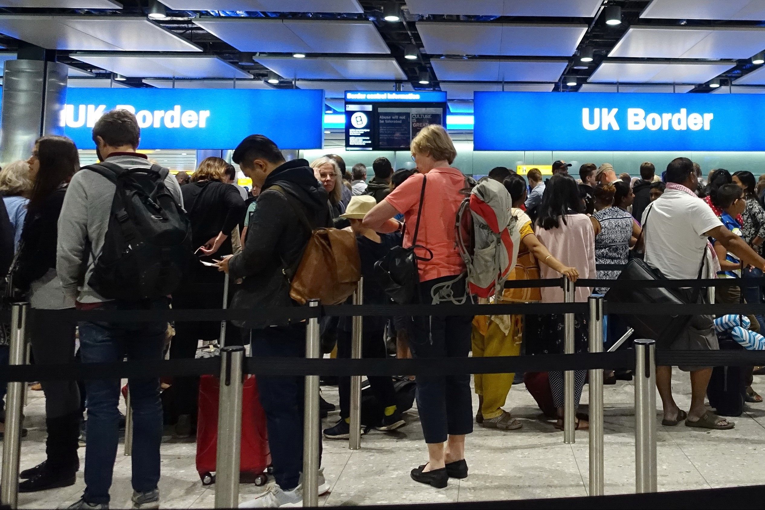 Passengers queuing at London Heathrow Airport