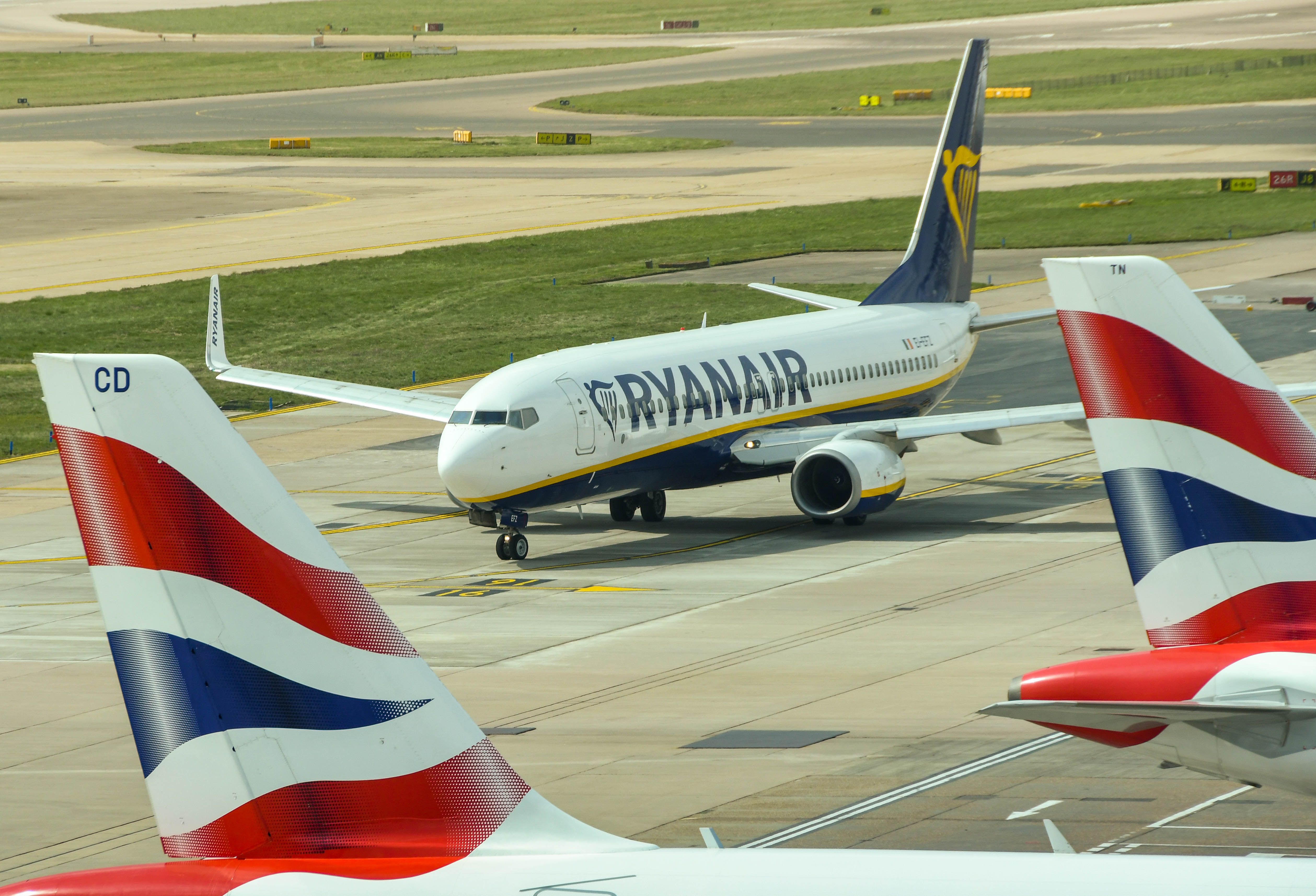 A Ryanair plane at London Gatwick Airport LGW among British Airways tails