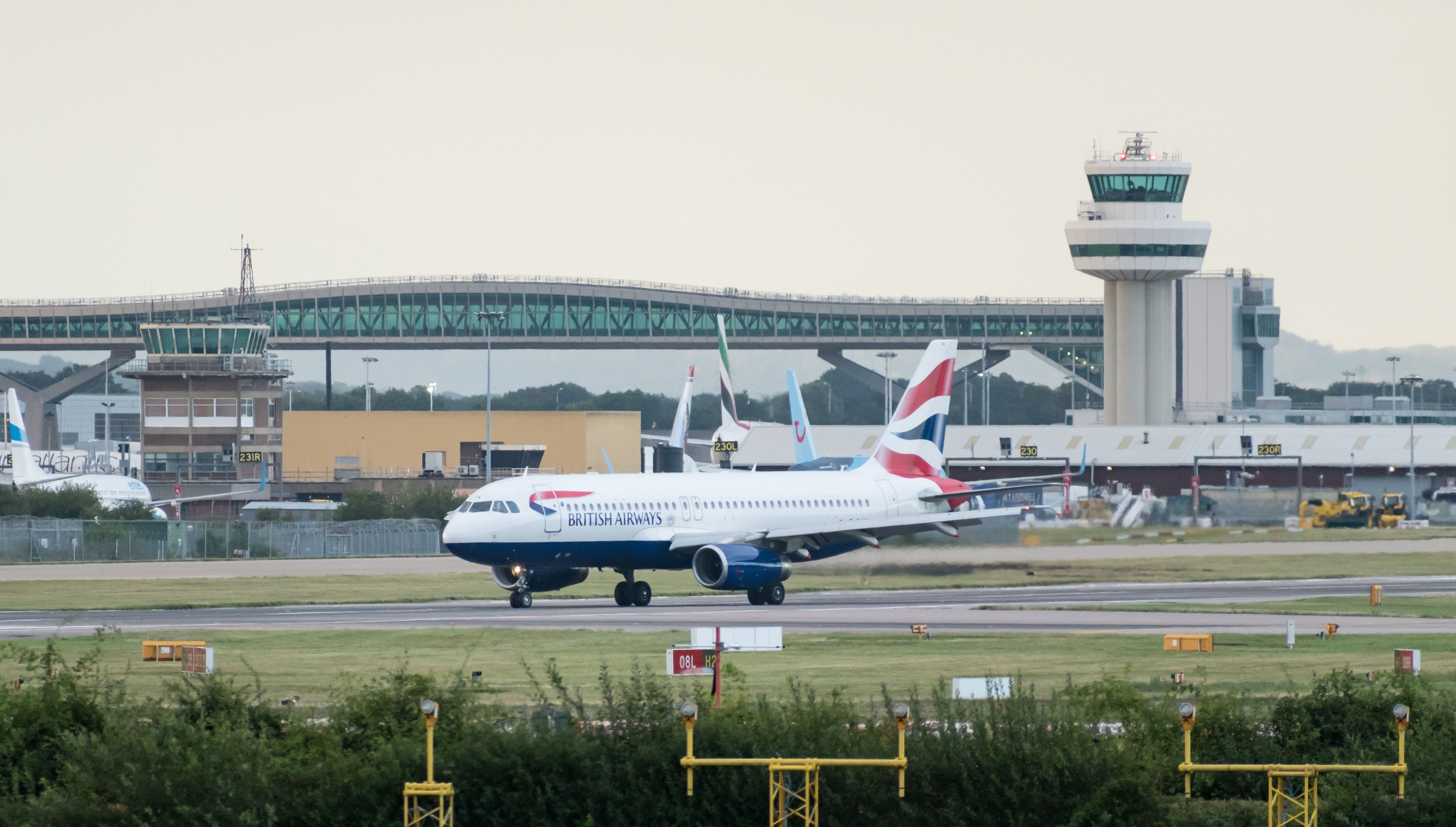 A British Airways plane in front of the Air Traffic Control Tower at London Gatwick Airport LGW