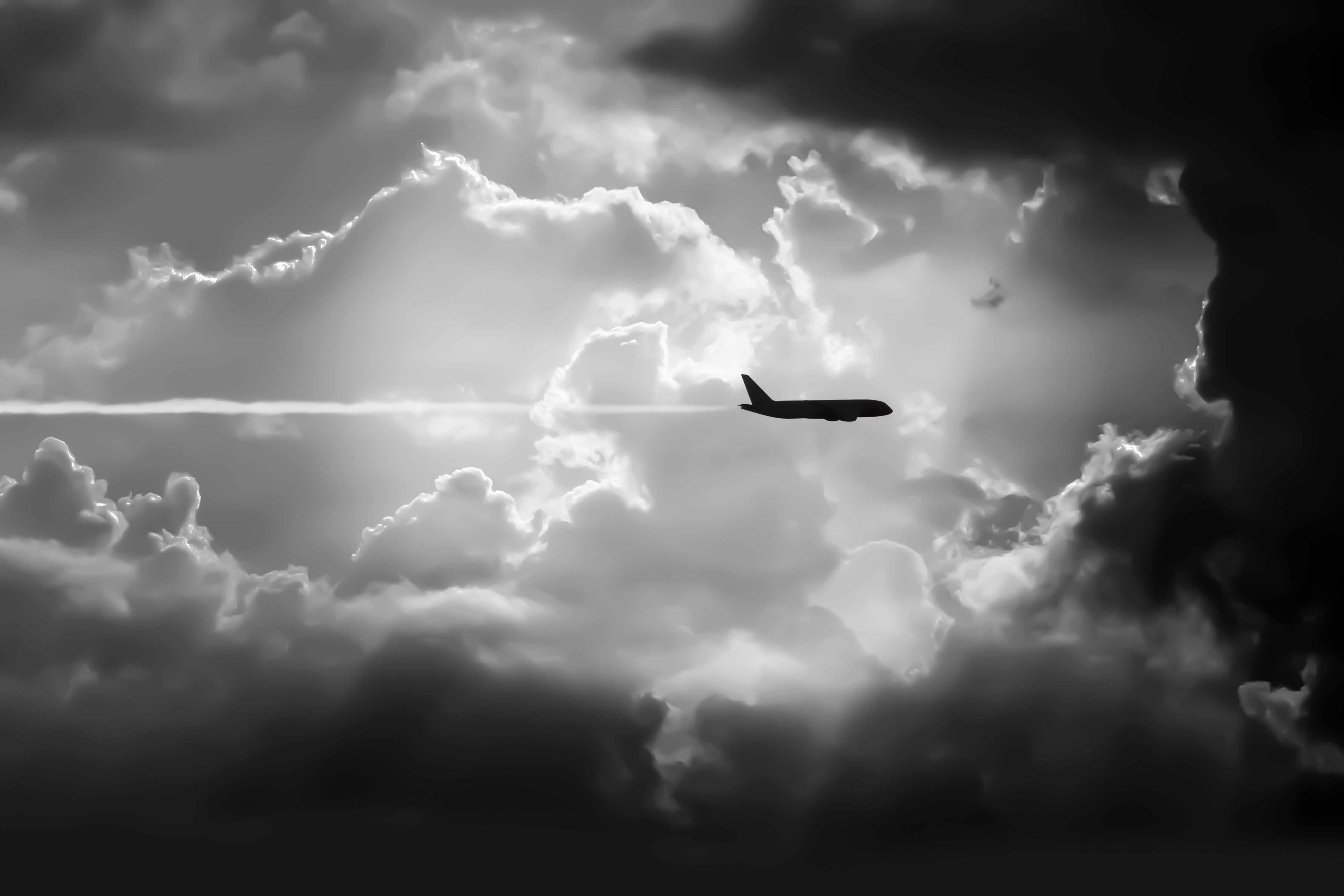 aircraft flying against dark storm clouds