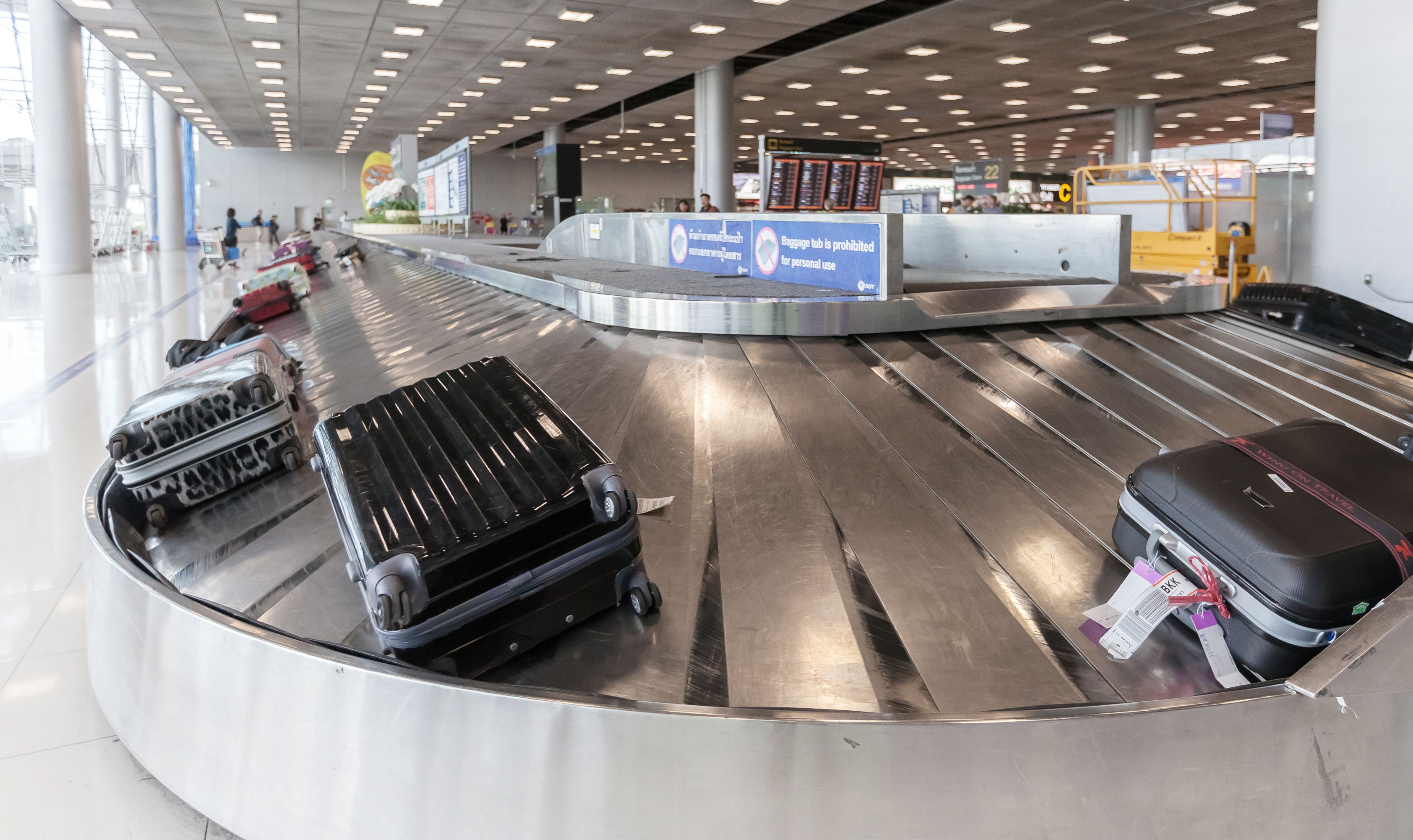 Baggage on a carousel waiting to be collected.