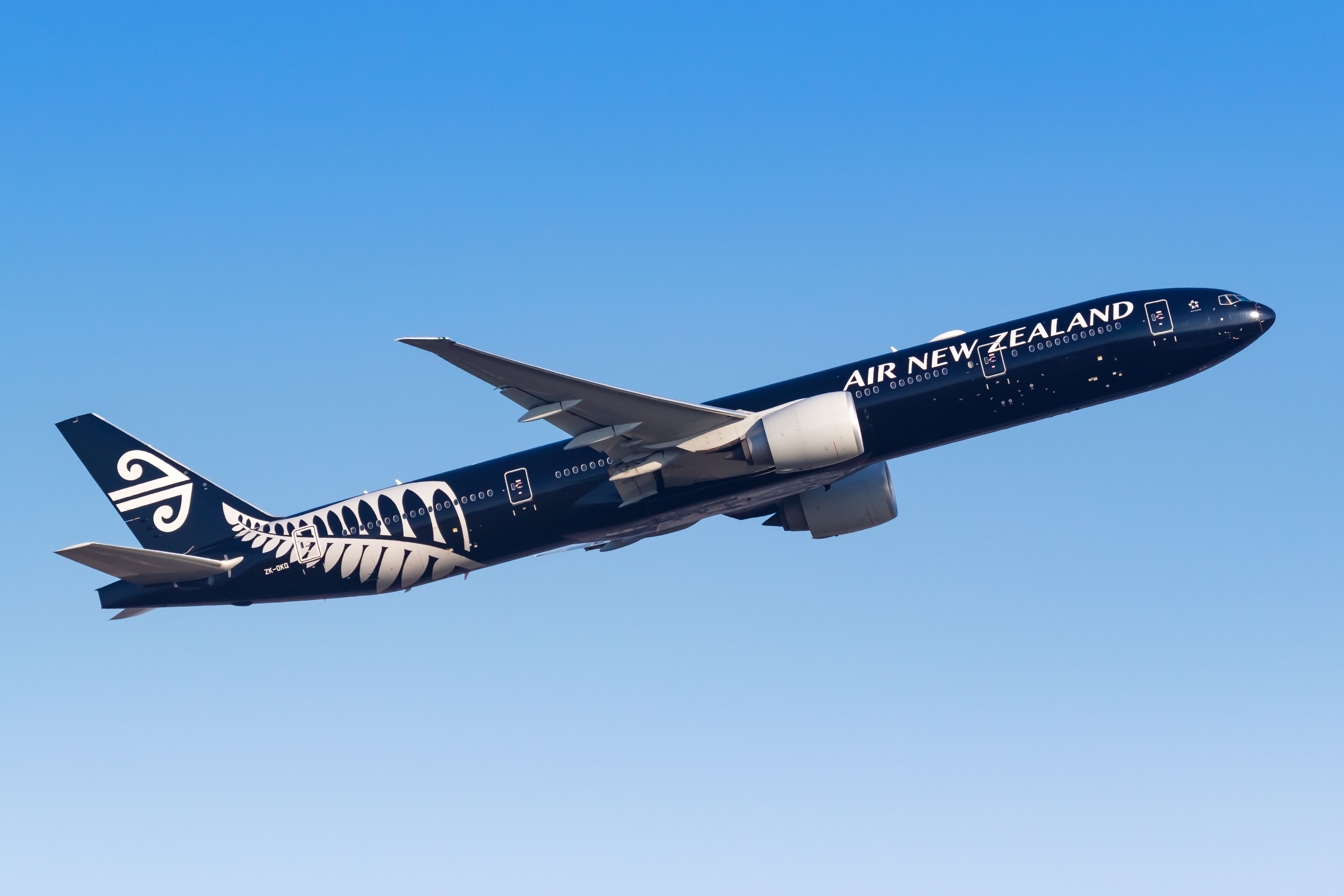 An Air New Zealand Boeing 777-300ER flying in the sky.