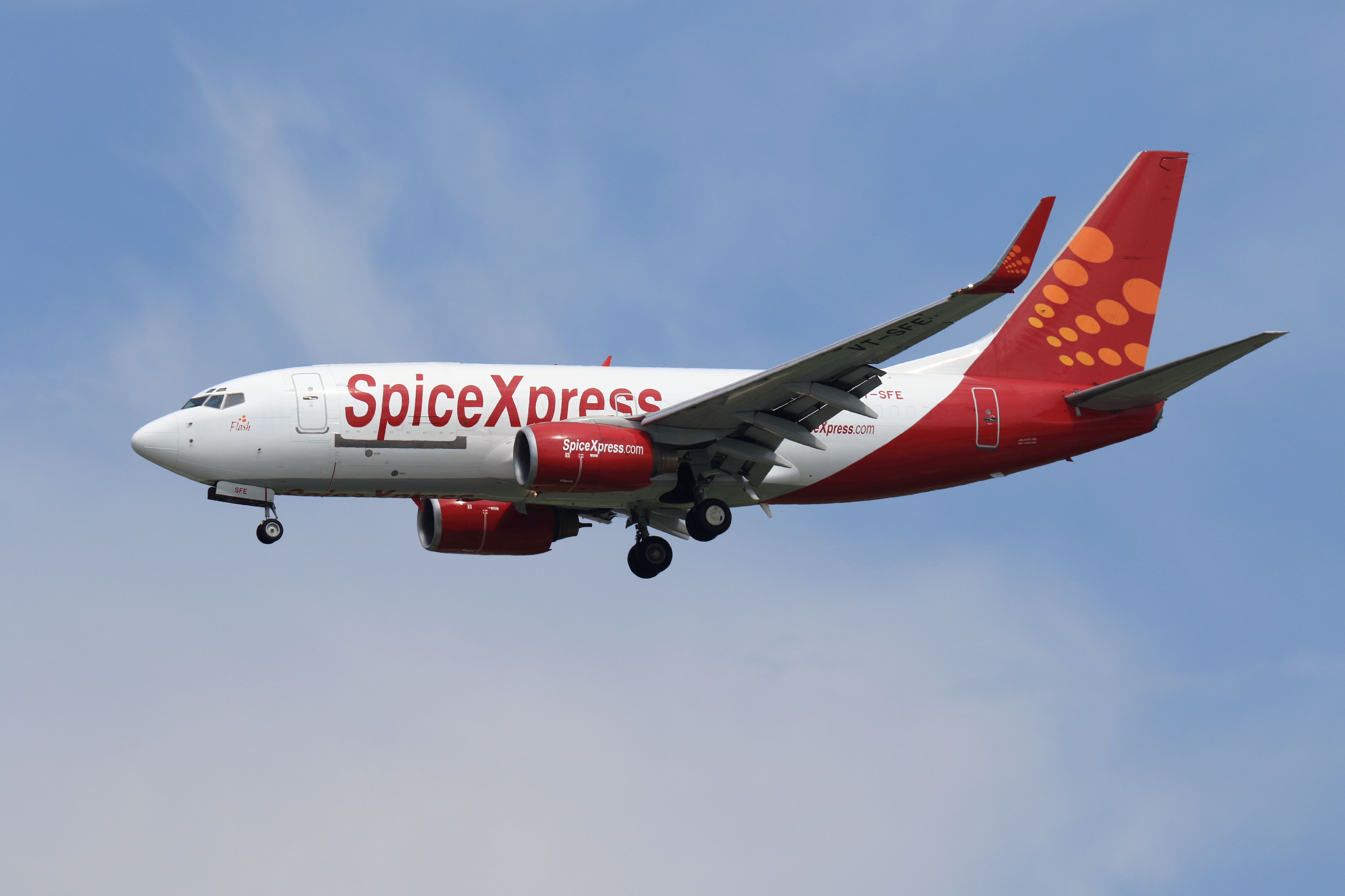 A SpiceXpress Boeing 737 flying in the sky.