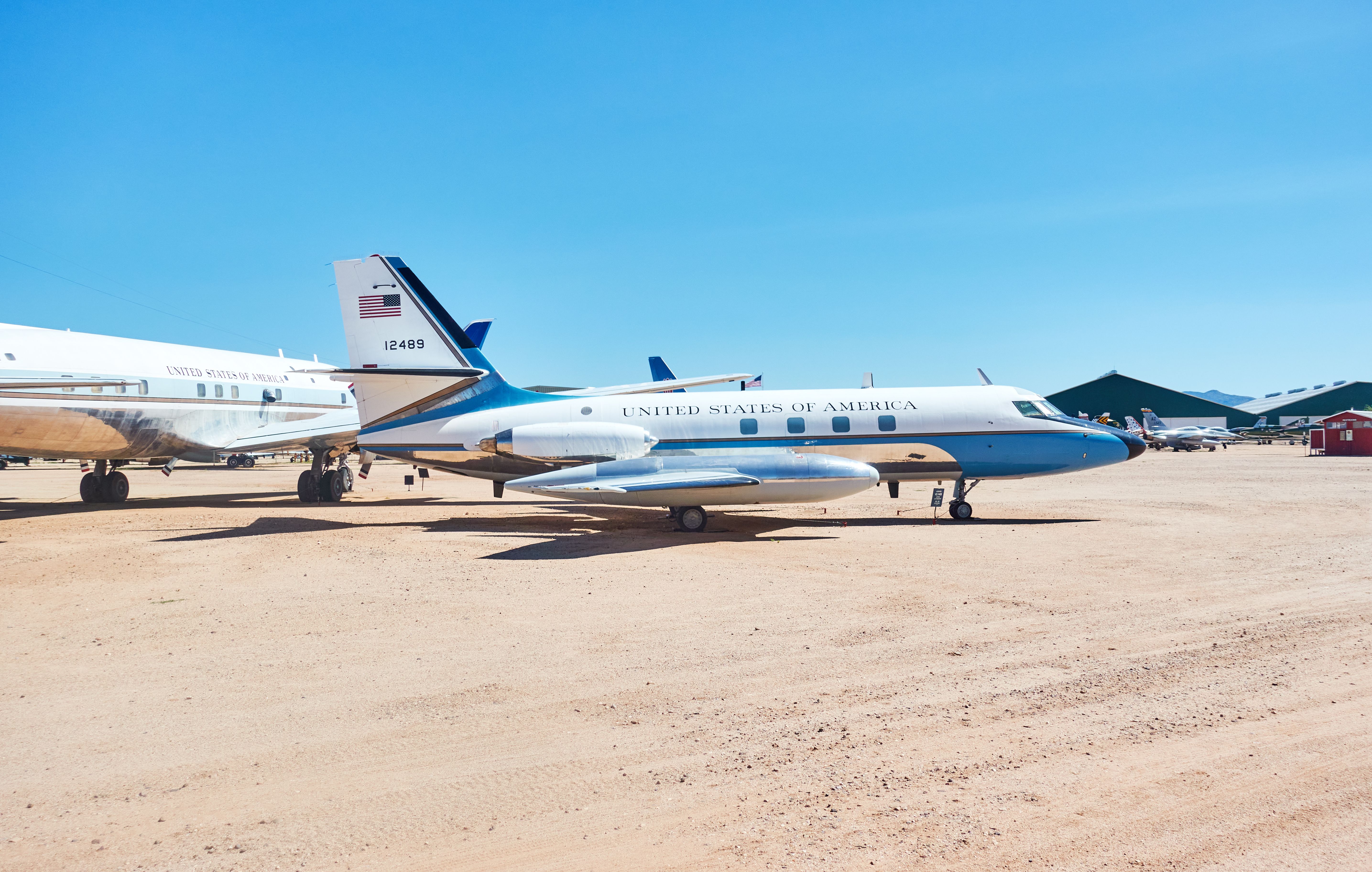 A US Government Lockheed JetStar parked in a desert.