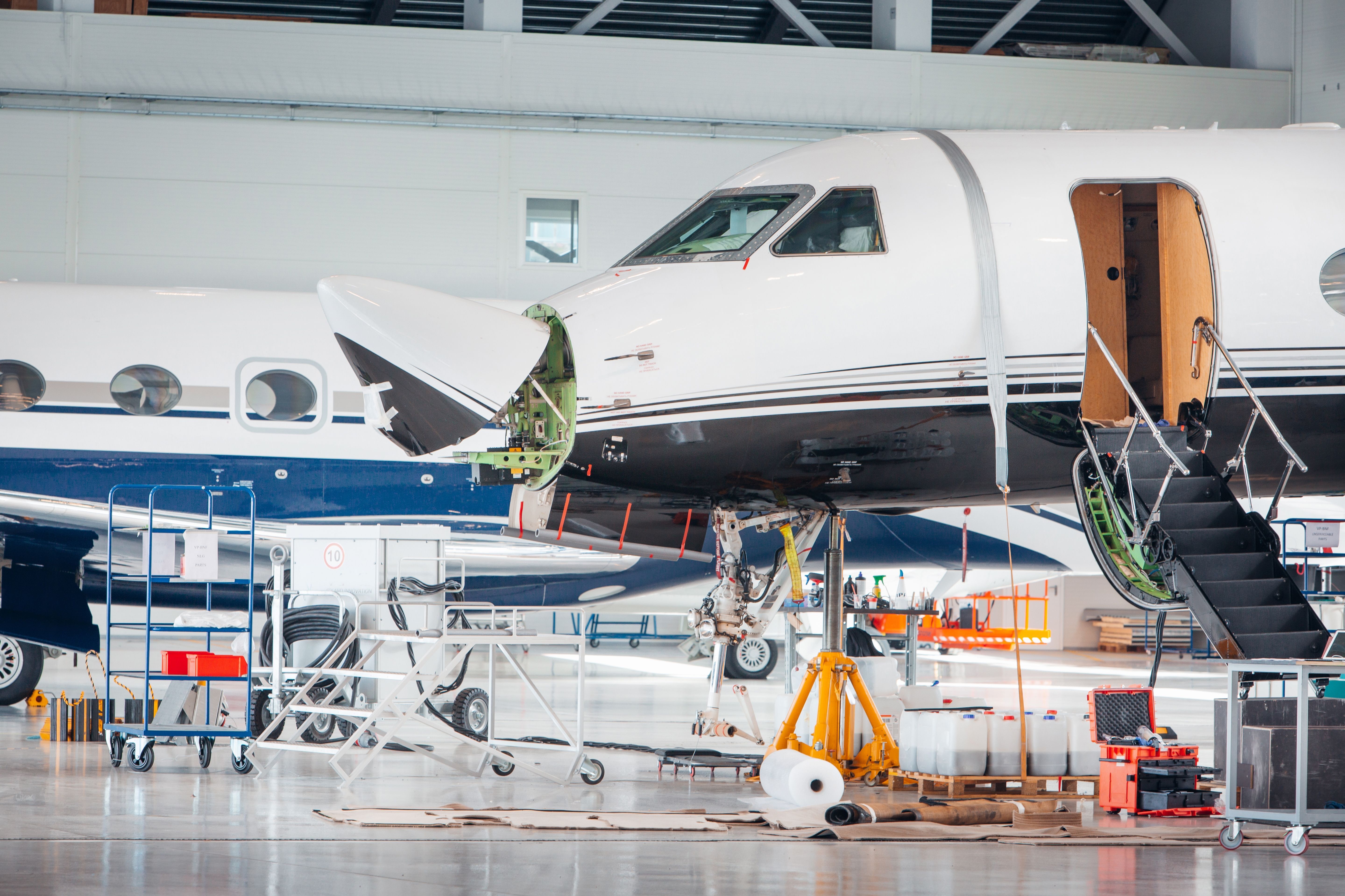 A private jet being worked on in a hangar.