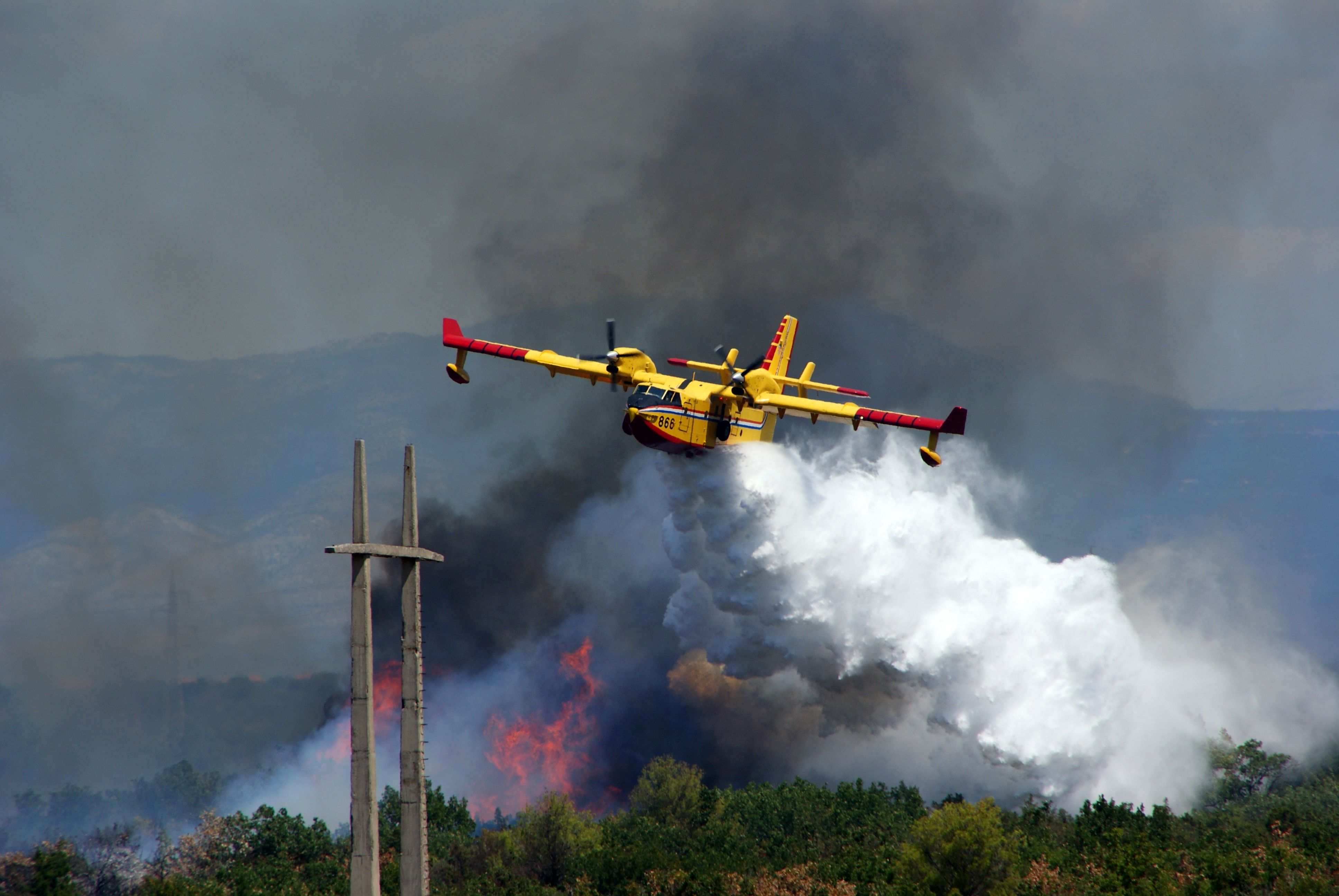 A CL-415 Being used to fight a fire.