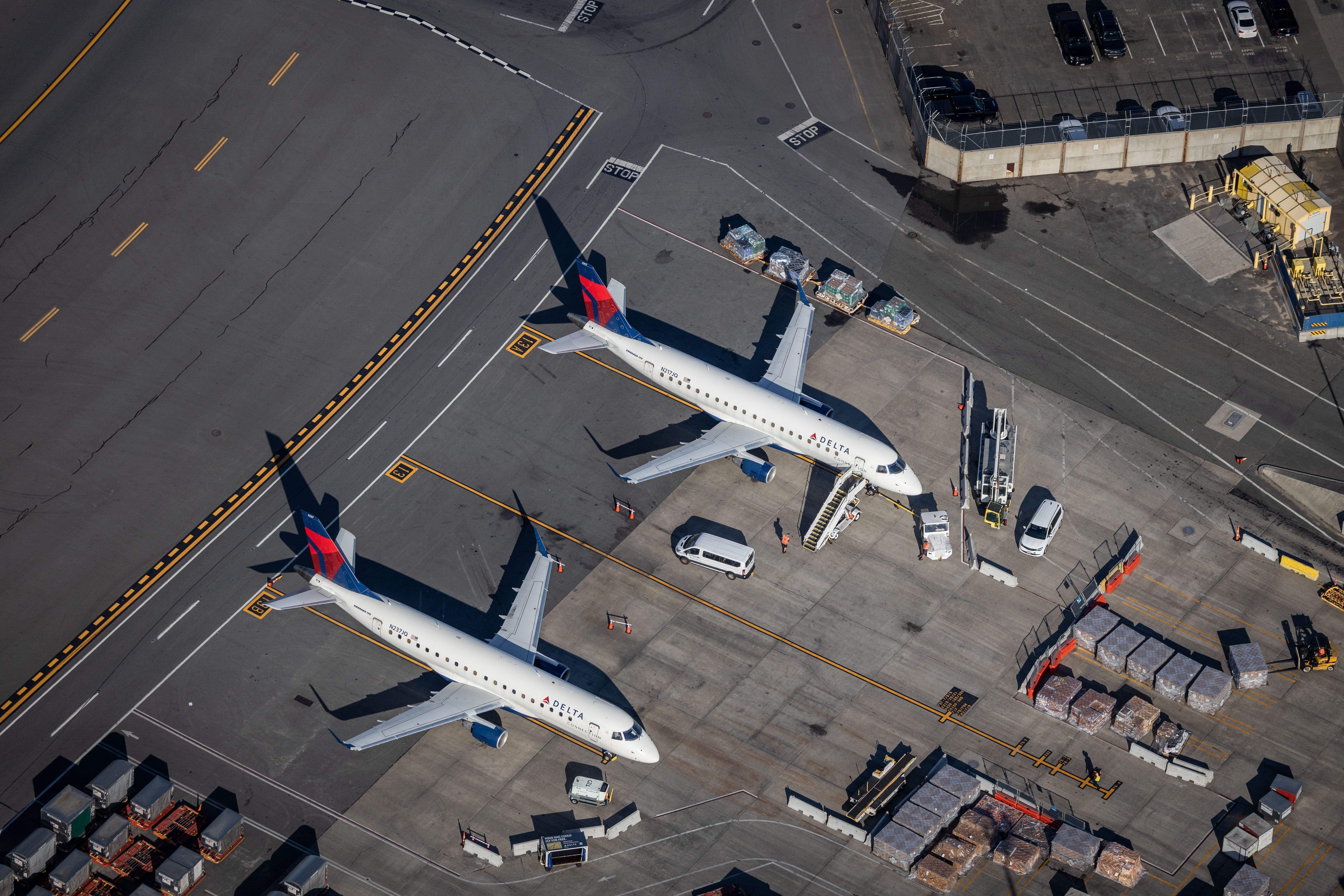 An aerial view of two Delta Airlines planes waiting at Boston's Logan Airport