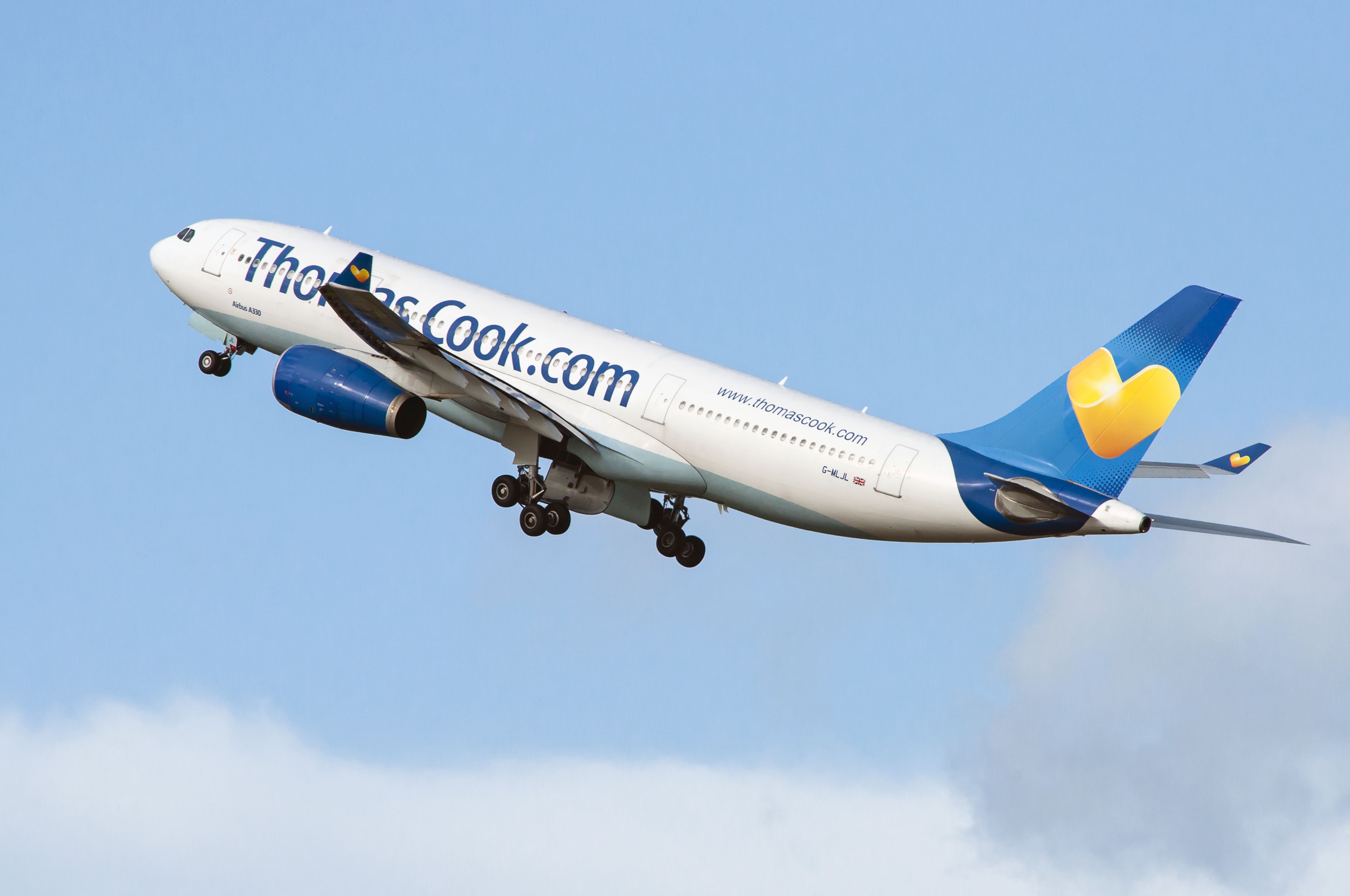 A Thomas Cook A330 flying in the sky.