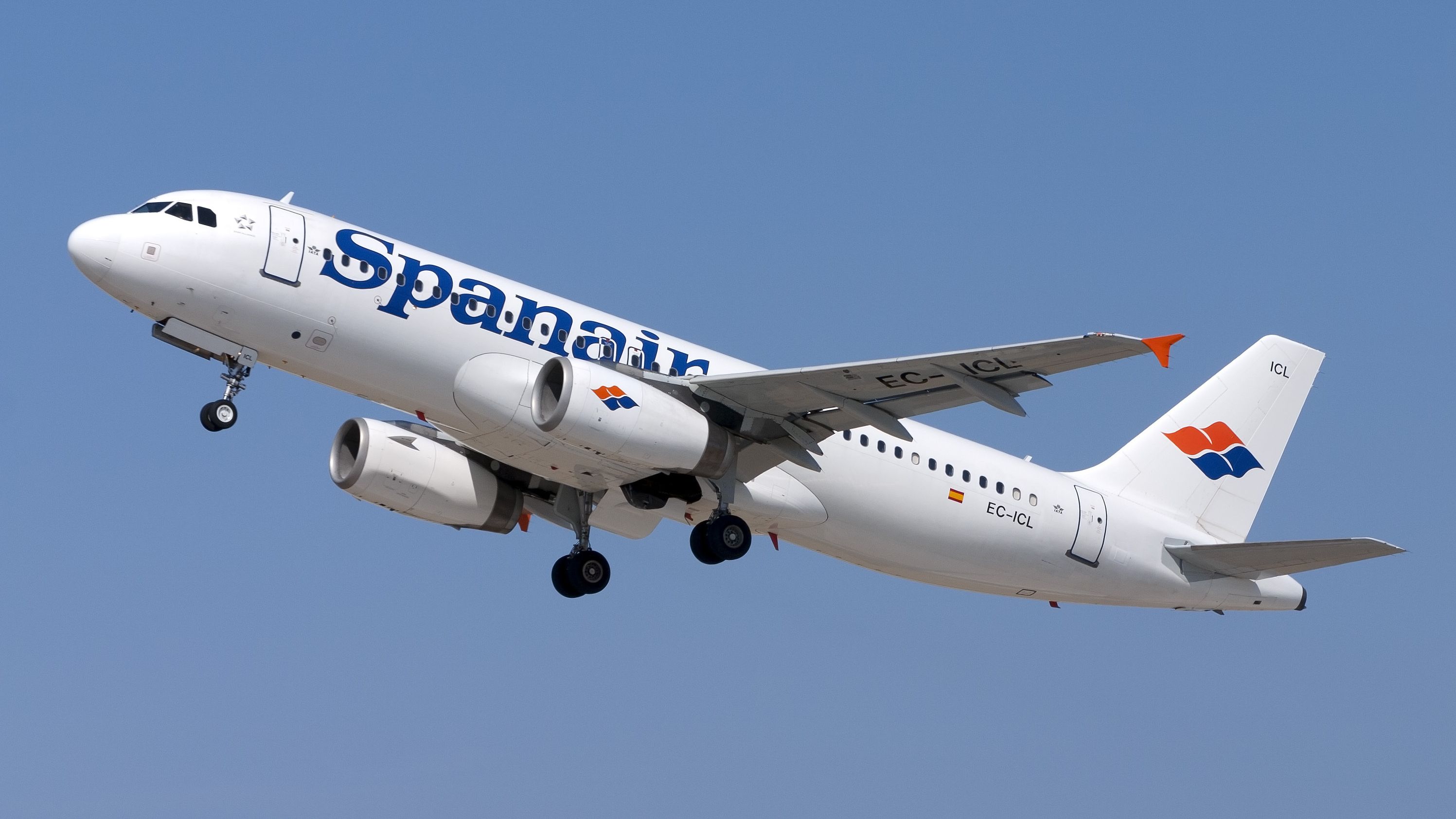 A Spanair aircraft flying in the sky.