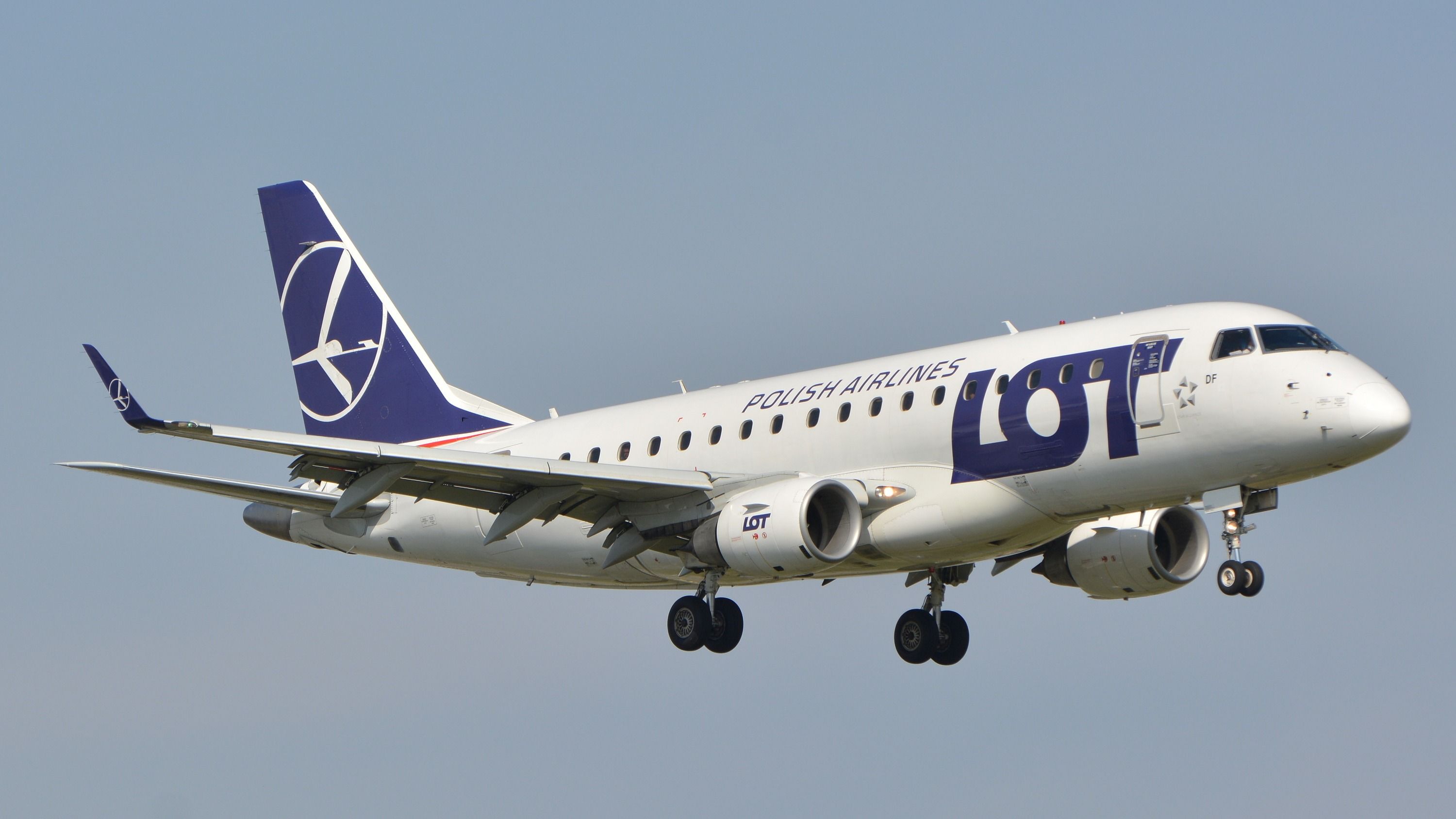 A LOT Polish Airlines Embraer E175 about to land.
