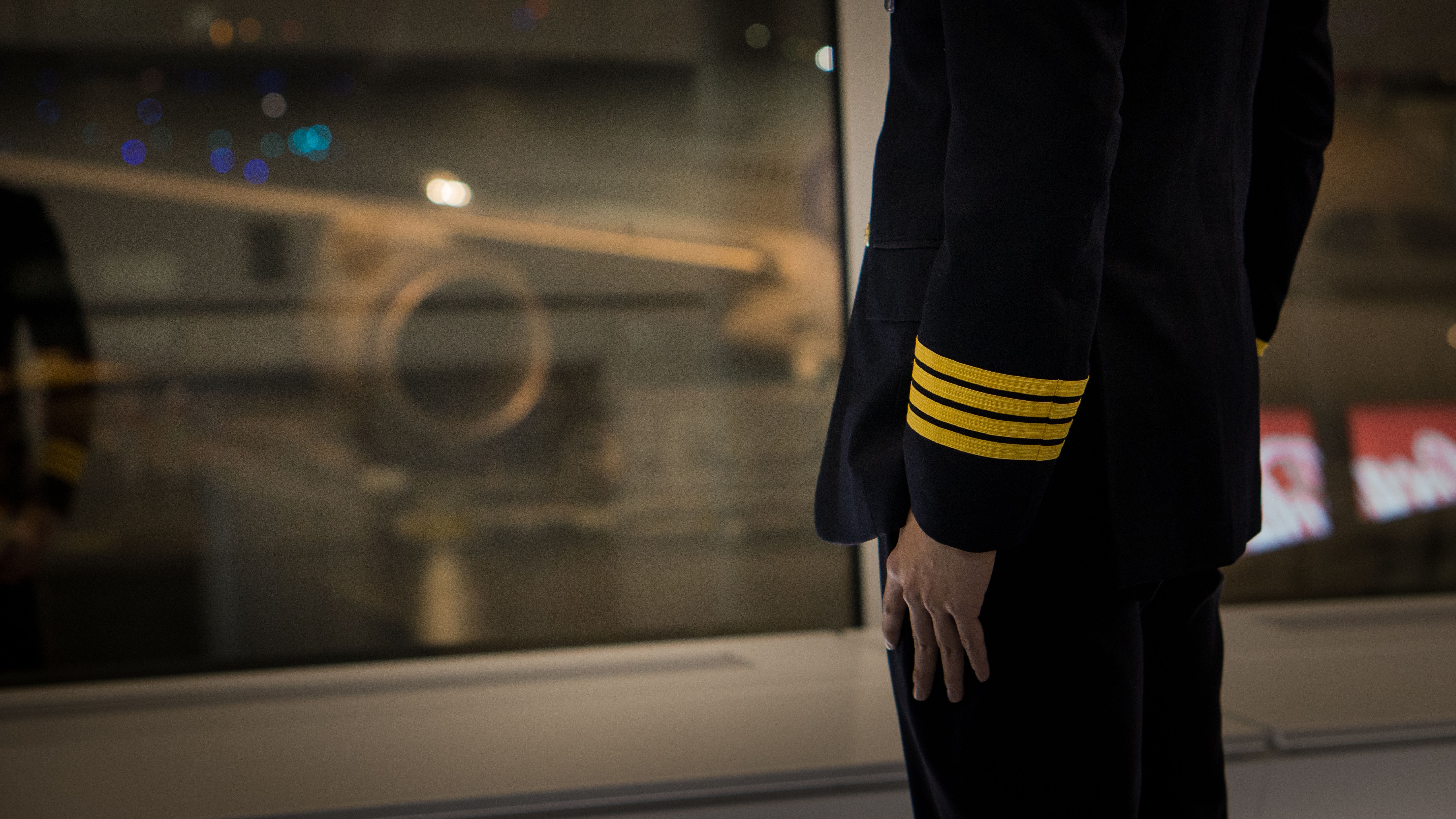 A captain looking at an aircraft from inside an airport terminal. 