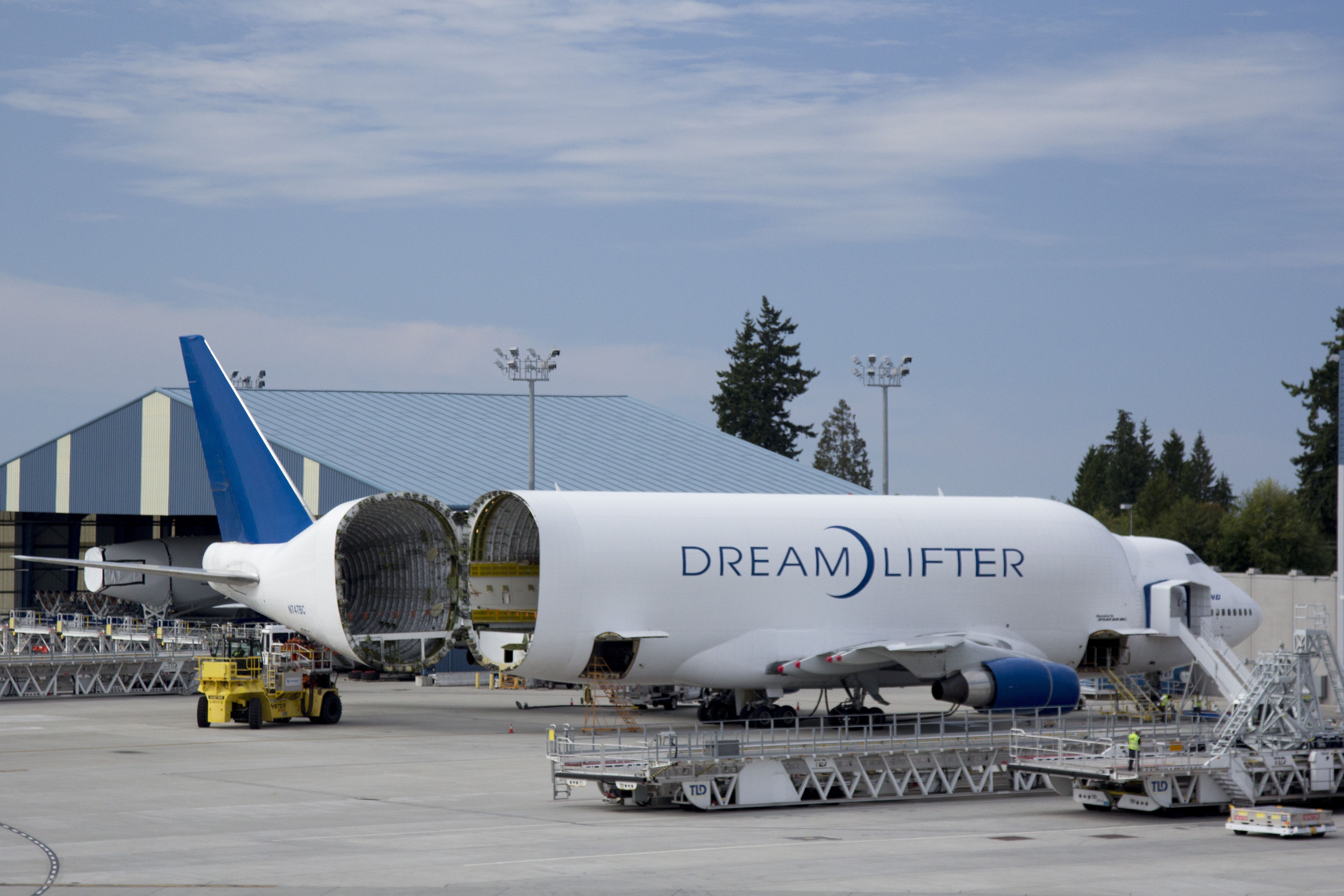 A Boeing Dreamlifter on the ground being loaded with cargo.