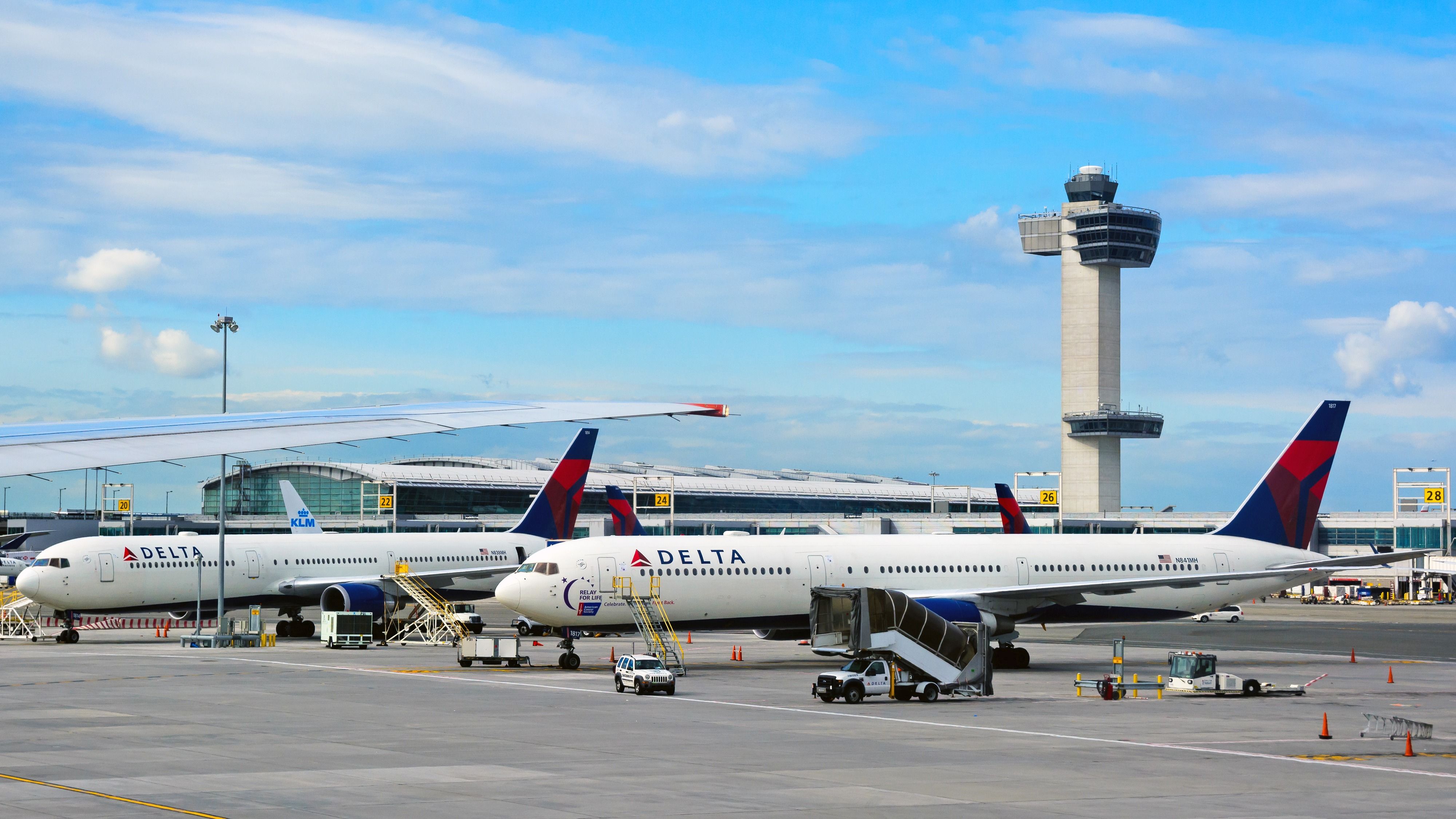 iew of apron of John F. Kennedy (JFK) International airport with parked Delta Air Lines' planes and the control tower in background