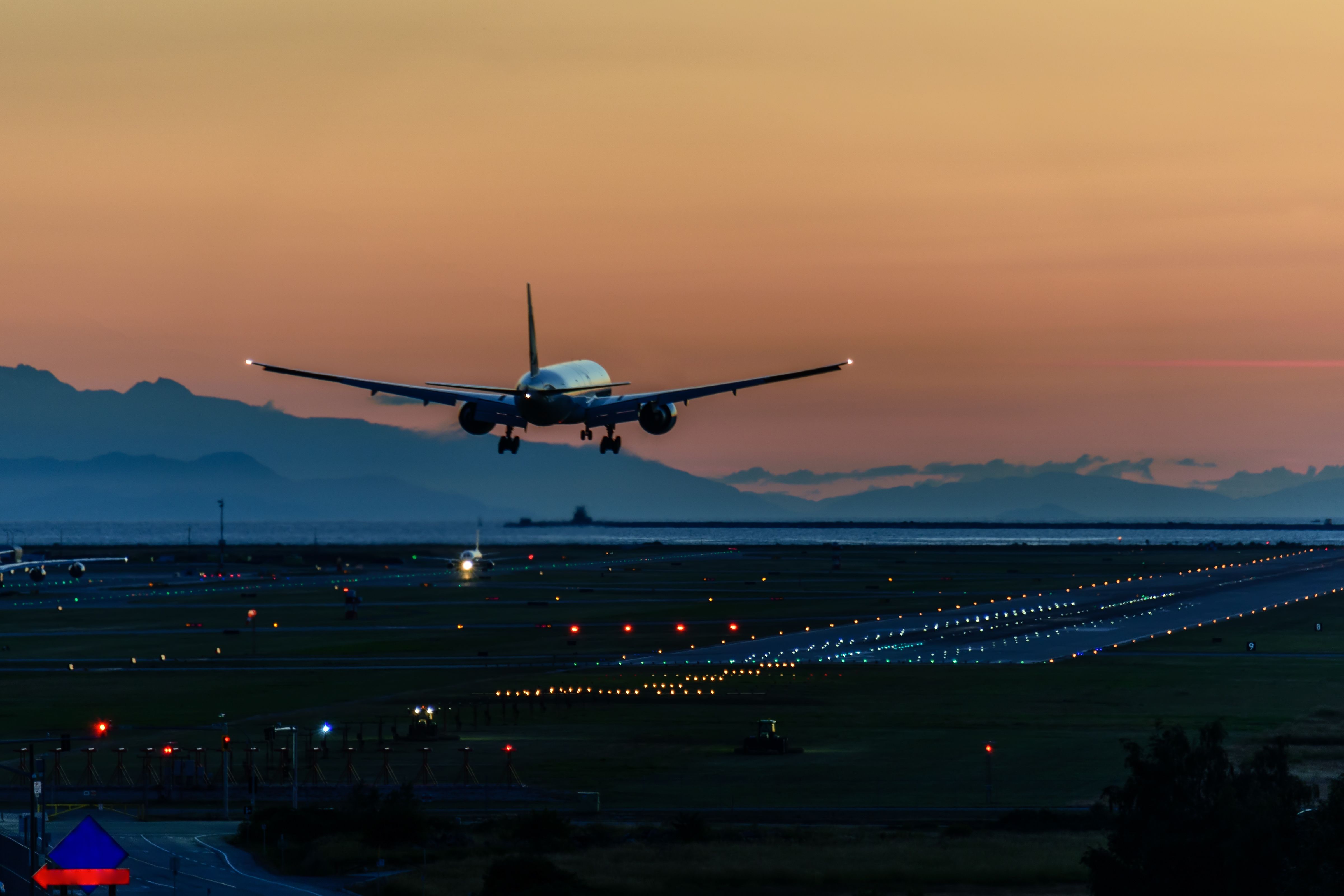 A Boeing 777 landing at twilight. 