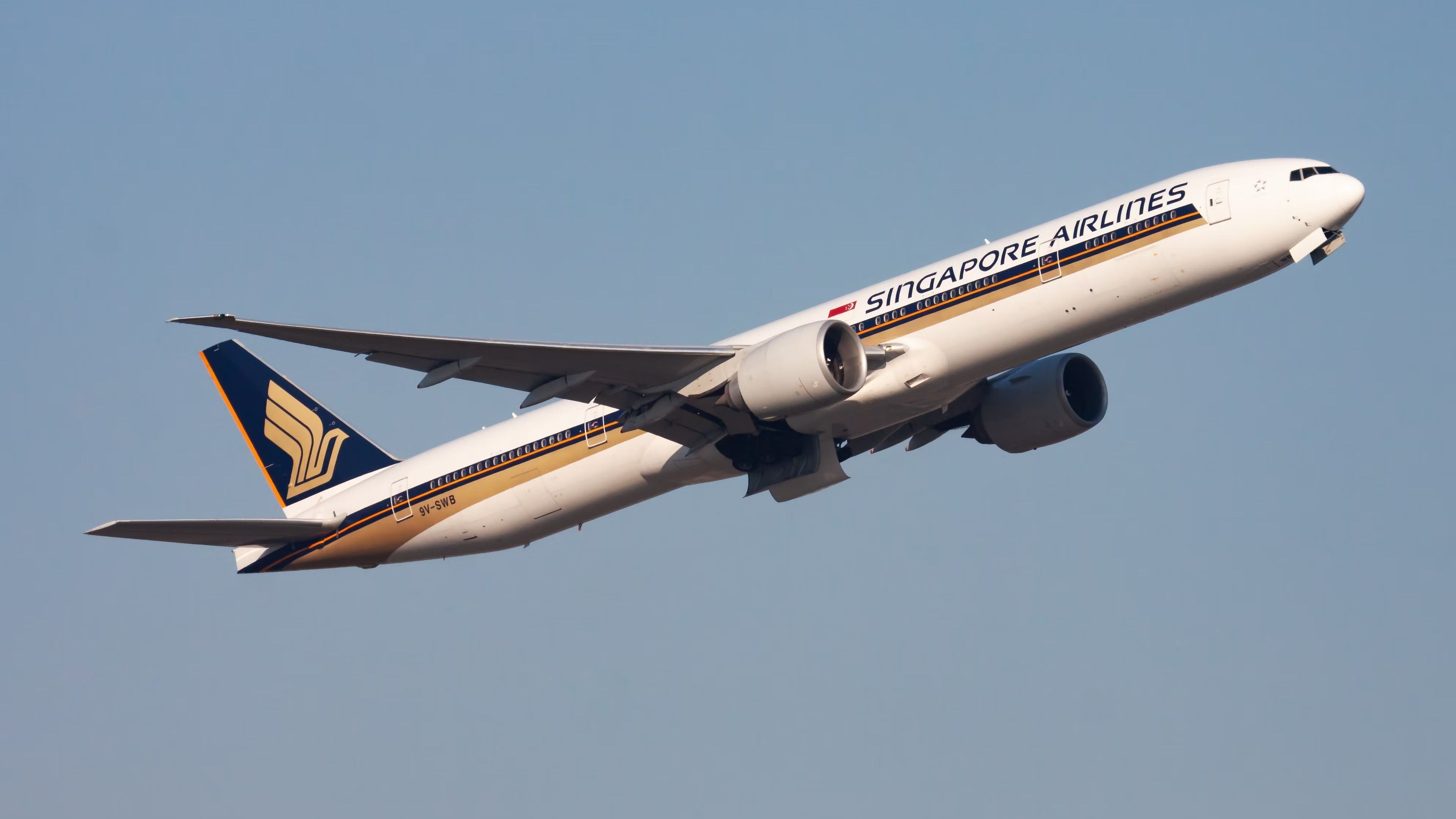 A Singapore Airlines Boeing 777-300ER flying in the sky.