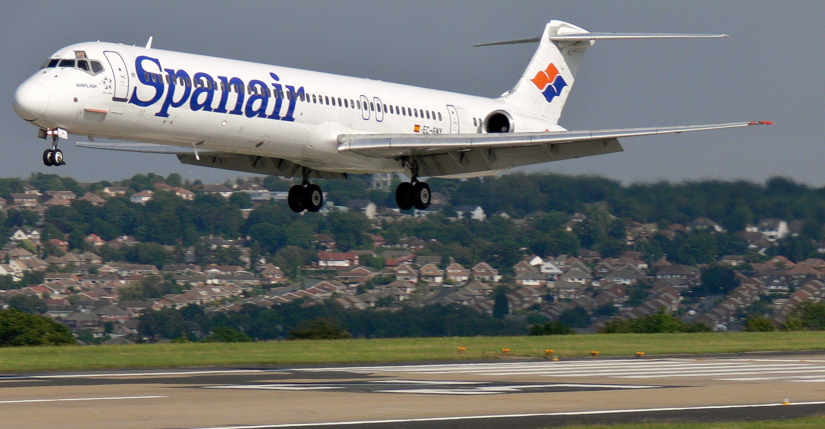 A Spanair MD-80 about to land on a runway.