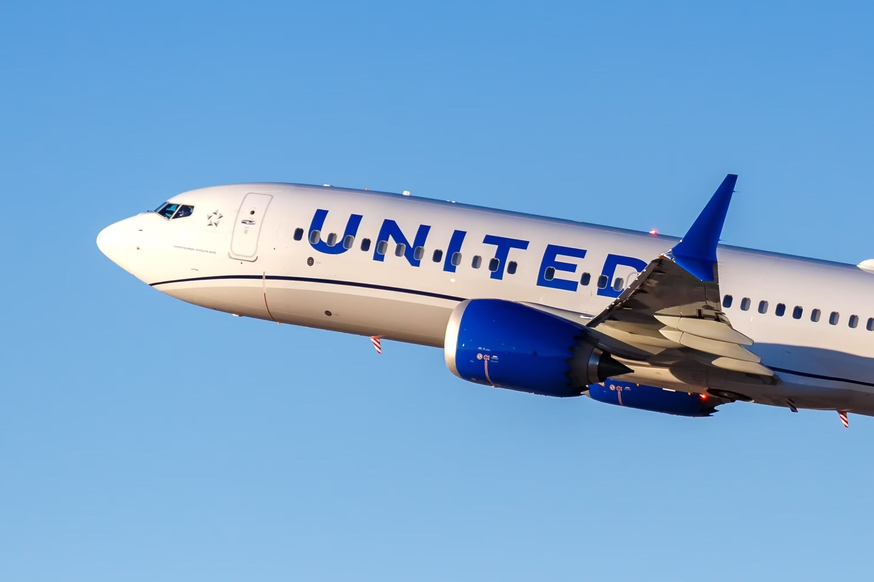A United Boeing 737 MAX flying in the sky.