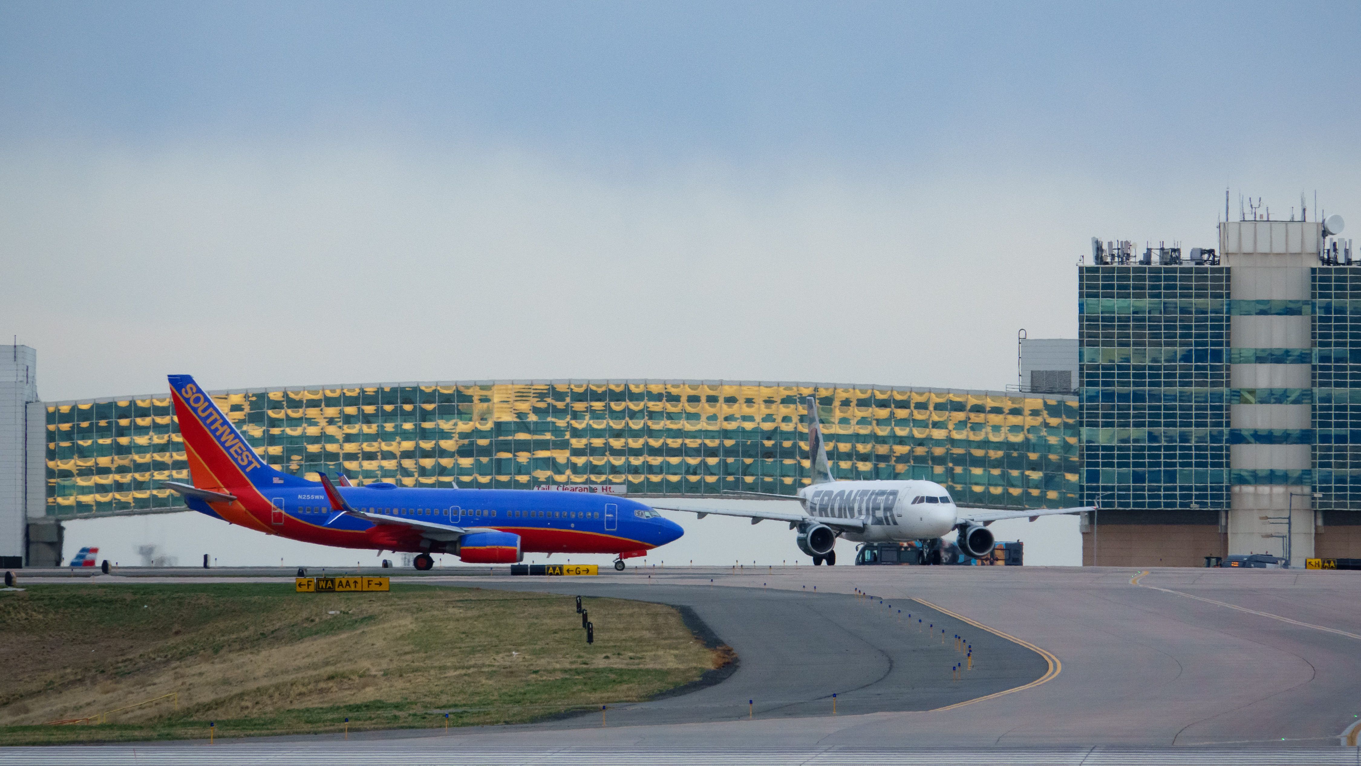 Southwest Airlines and Frontier aircraft taxiing at Denver International Airport.