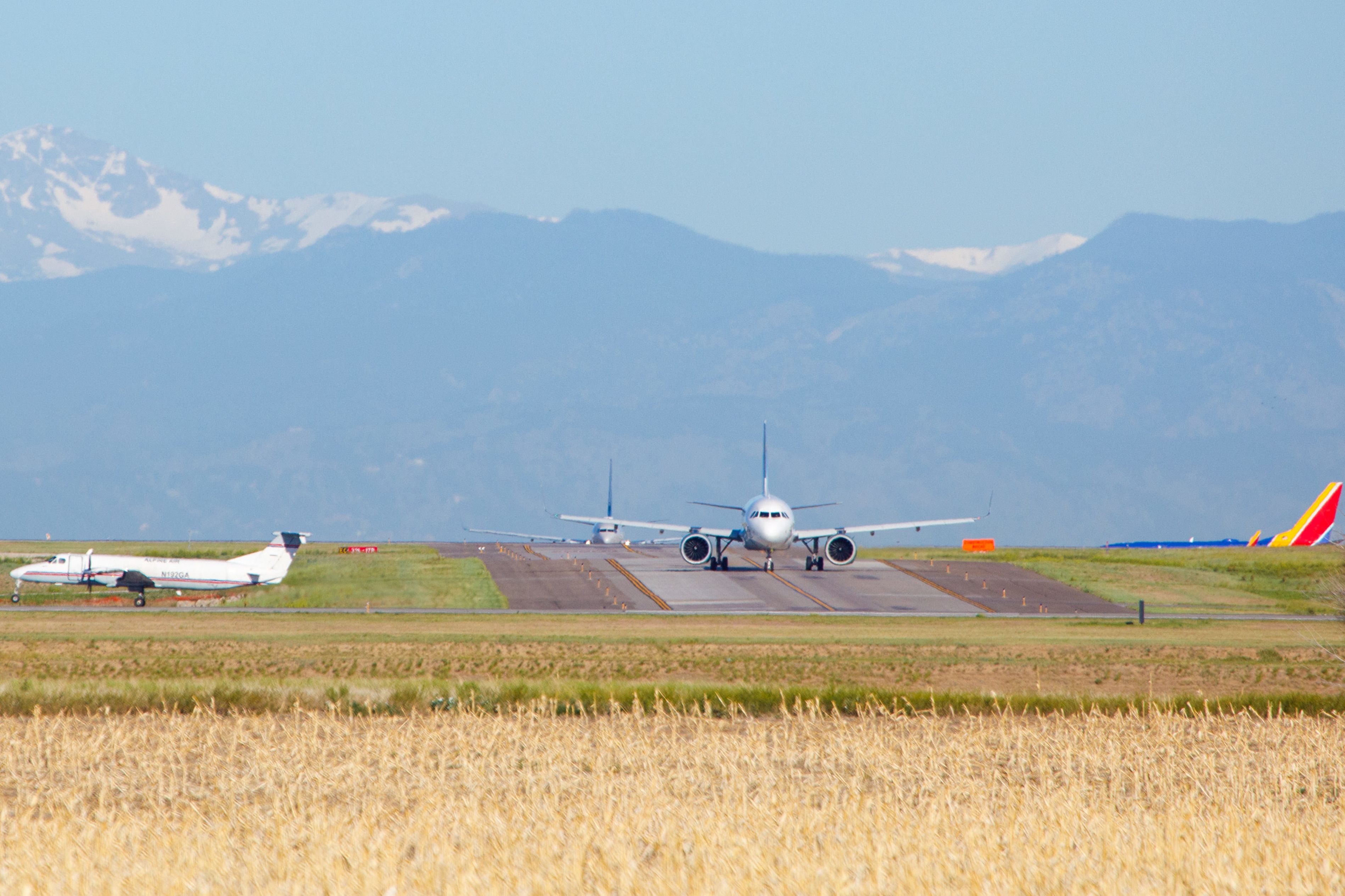 Several aircraft taxiing at Denver International Airport.