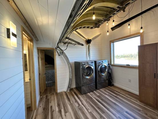 a laundry room with a wood floor and a wood floor