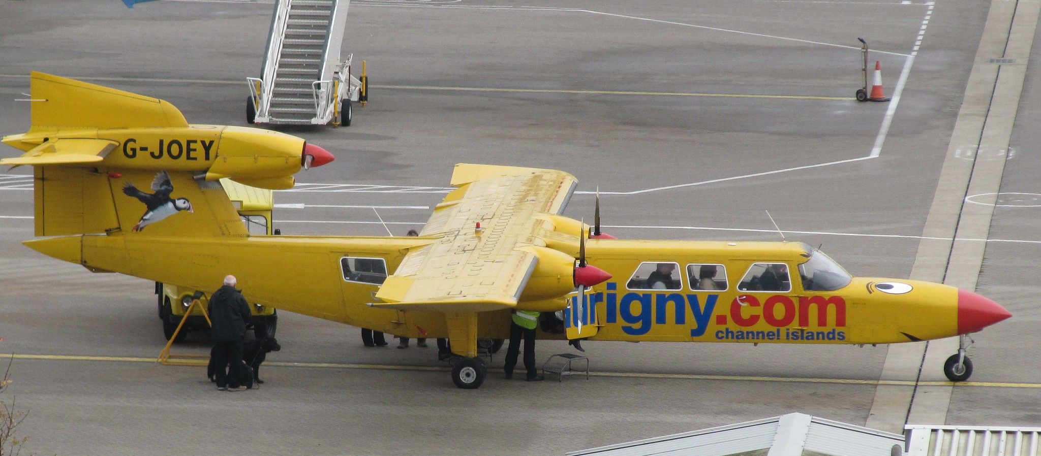 An Aurigny Britten-Norman Trislander parked at an airport.