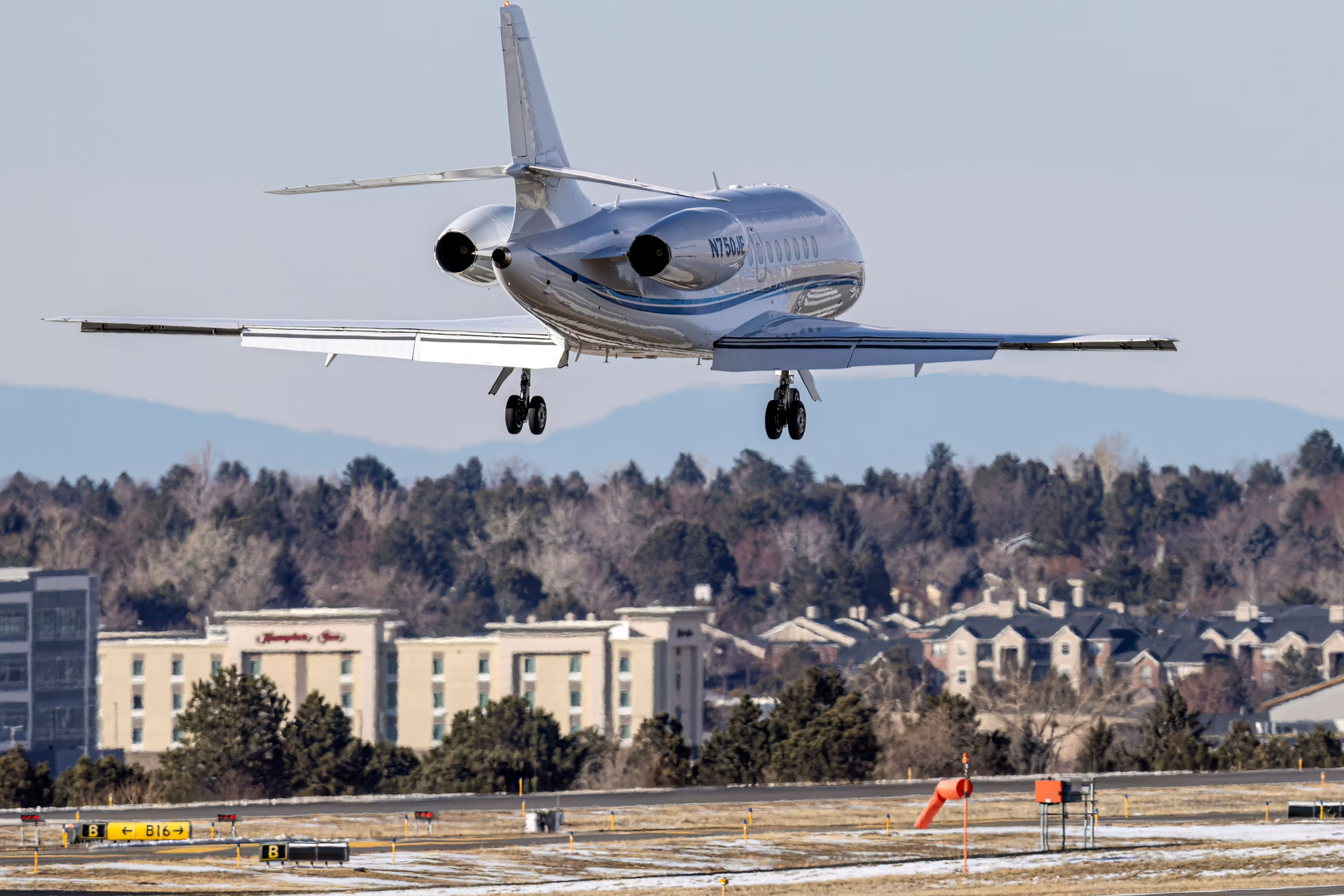 A Dassault Falcon 2000 about to land on a runway.