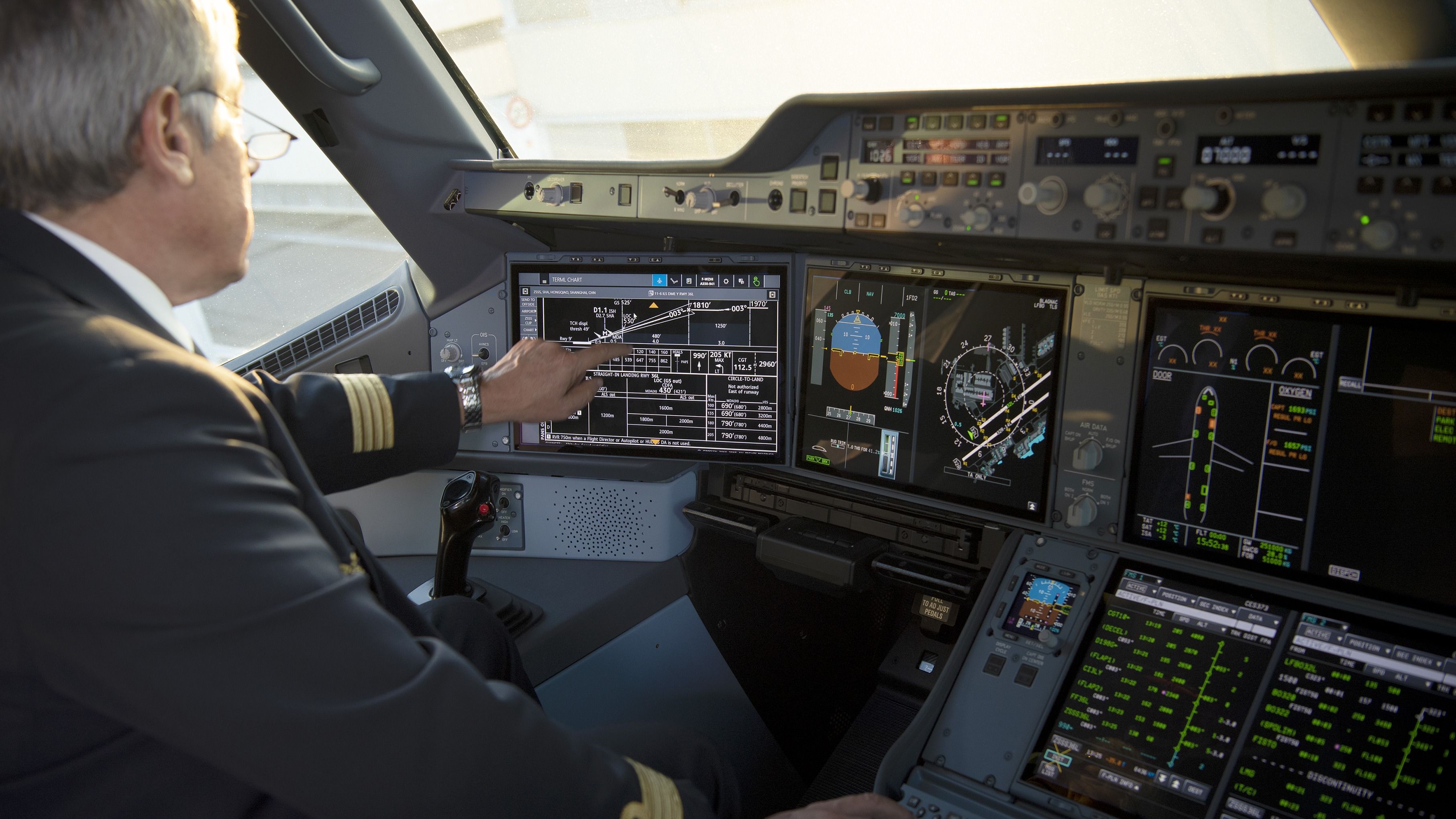 An A350 captain sitting in the cockpit.