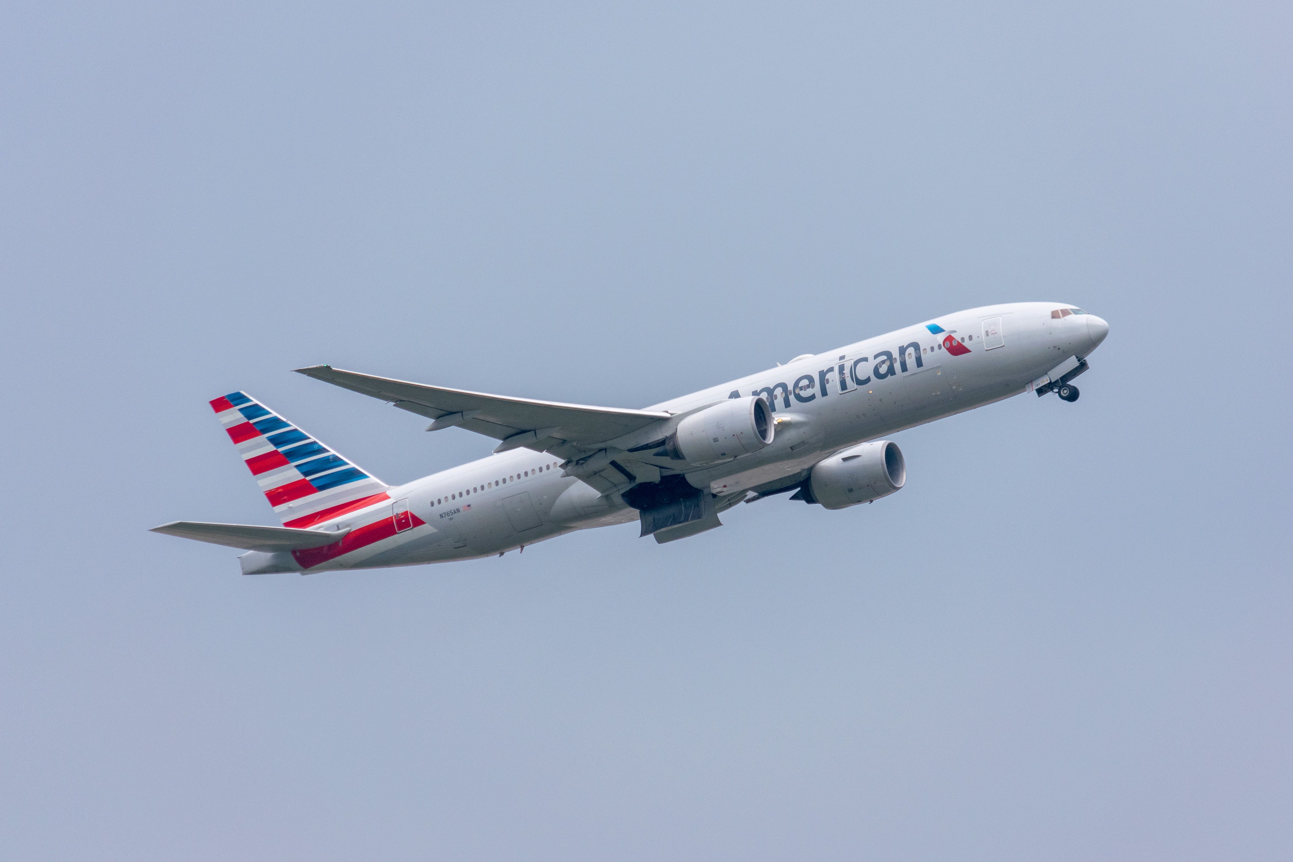 An American Airlines Boeing 777-200ER Flying in the sky..