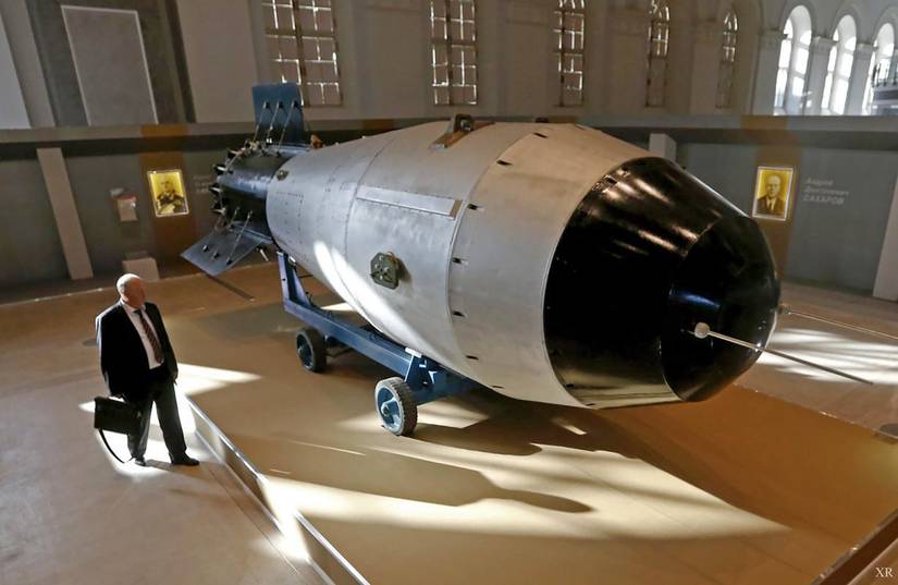 A person standing near a replica of the Tsar Bomba.