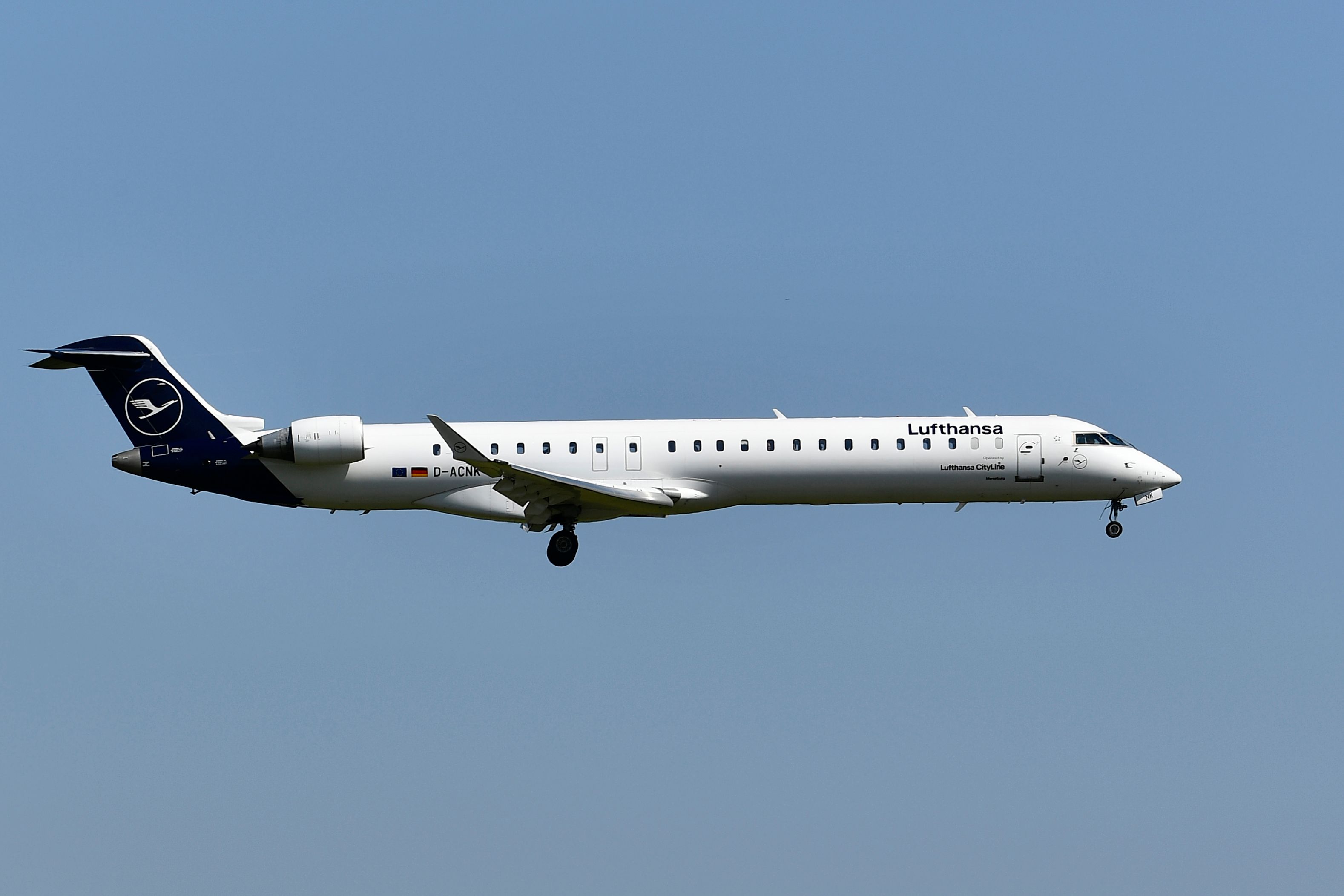 A Lufthansa CityLine CRJ900LR flying in the sky.
